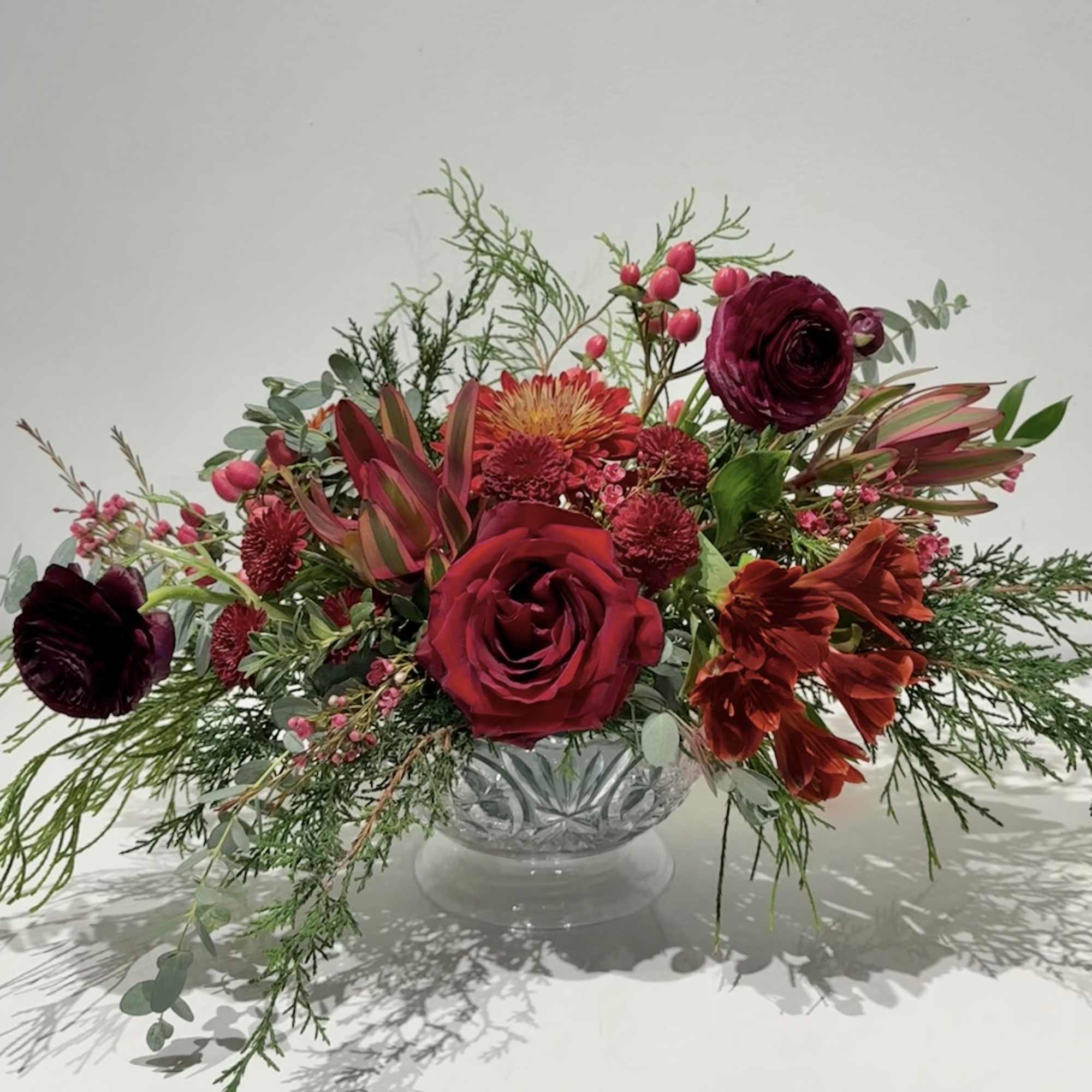 Celebrate the season with this luxurious Christmas centerpiece featuring heritage mums, leucadendron