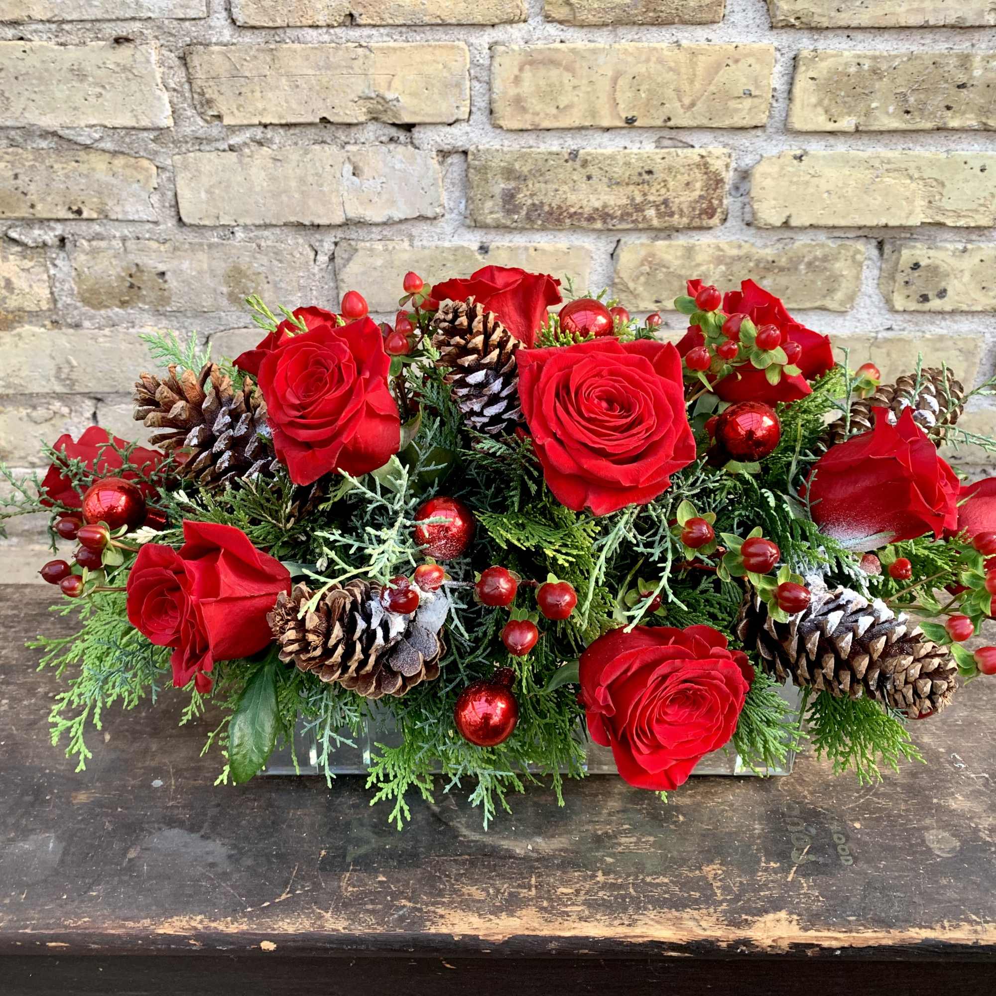 Lush Holiday Arrangement With Pine Cones, Roses, Hypericum 
and Winter Greens. This