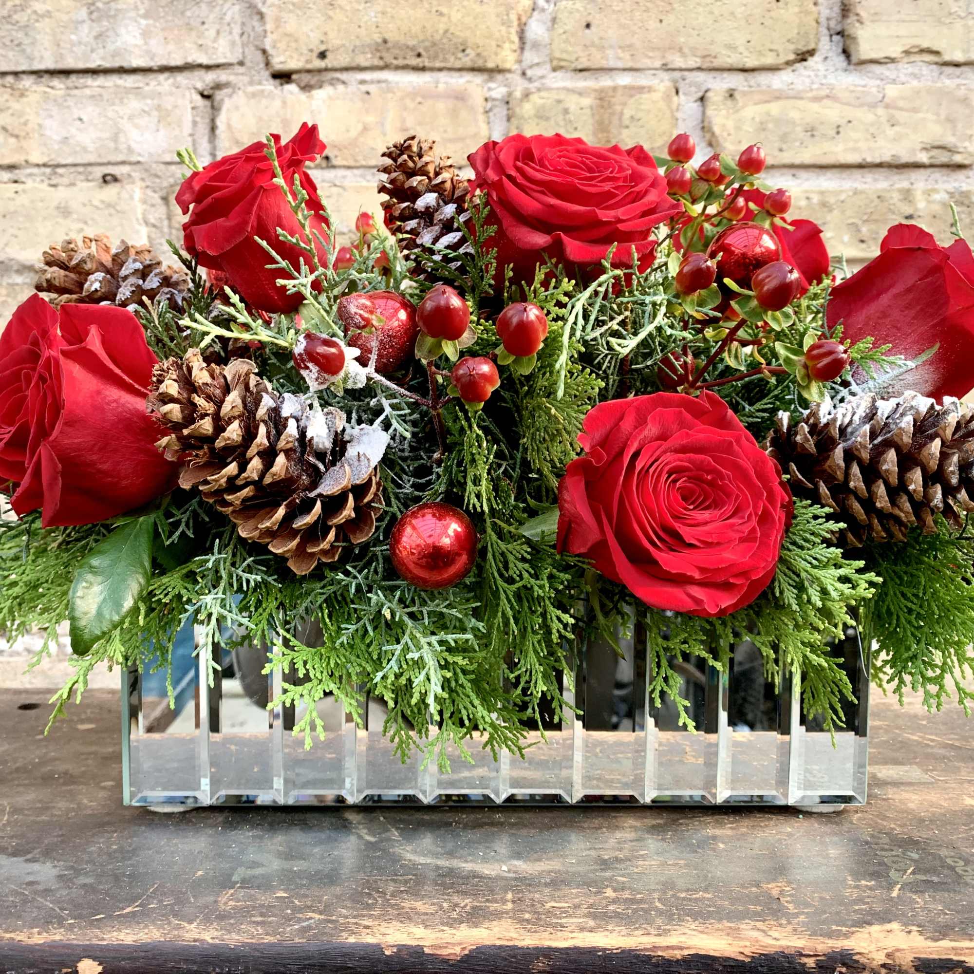 Lush Holiday Arrangement With Pine Cones, Roses, Hypericum 
and Winter Greens. This