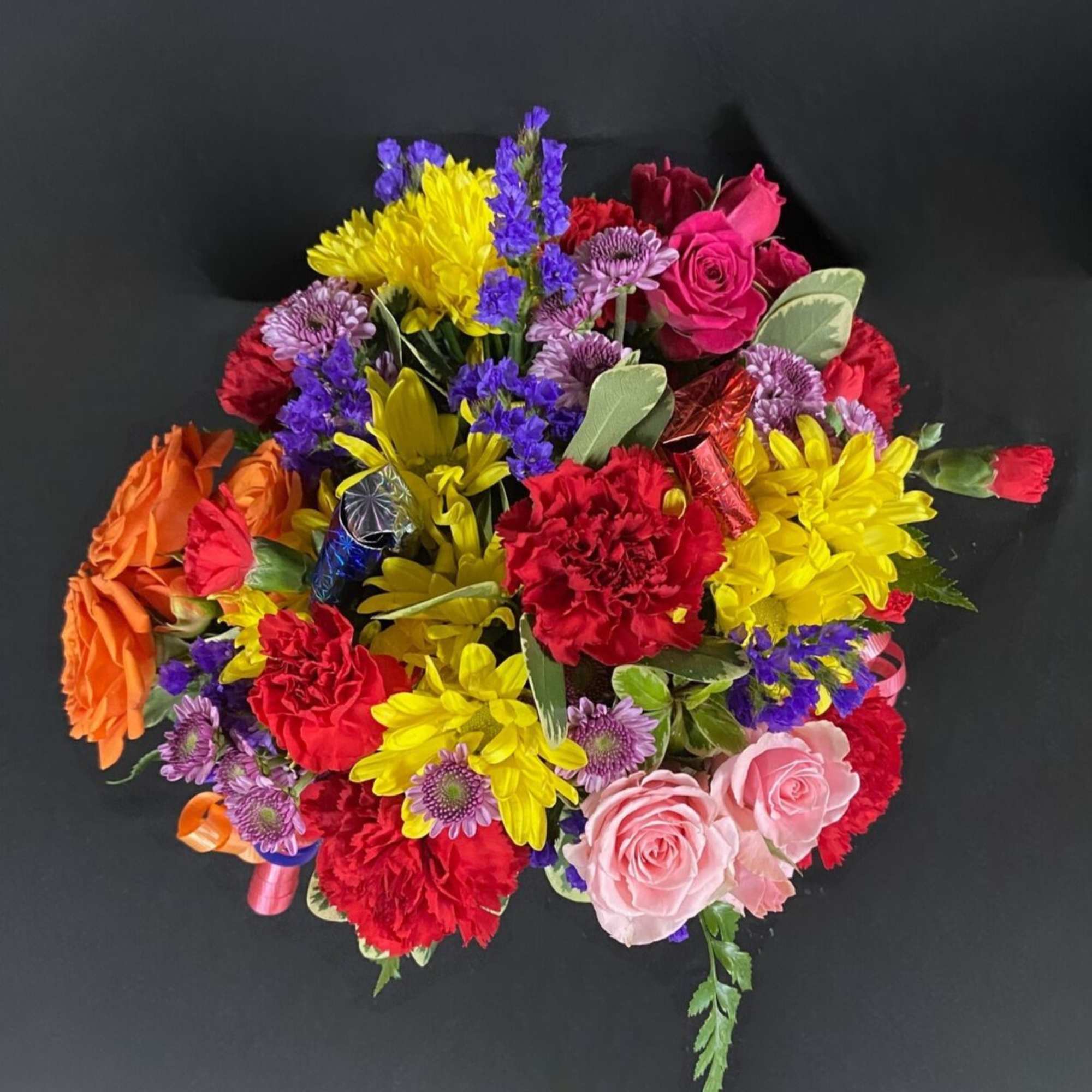 A frosted globe is decorated with birthday candles and filled with seasonal