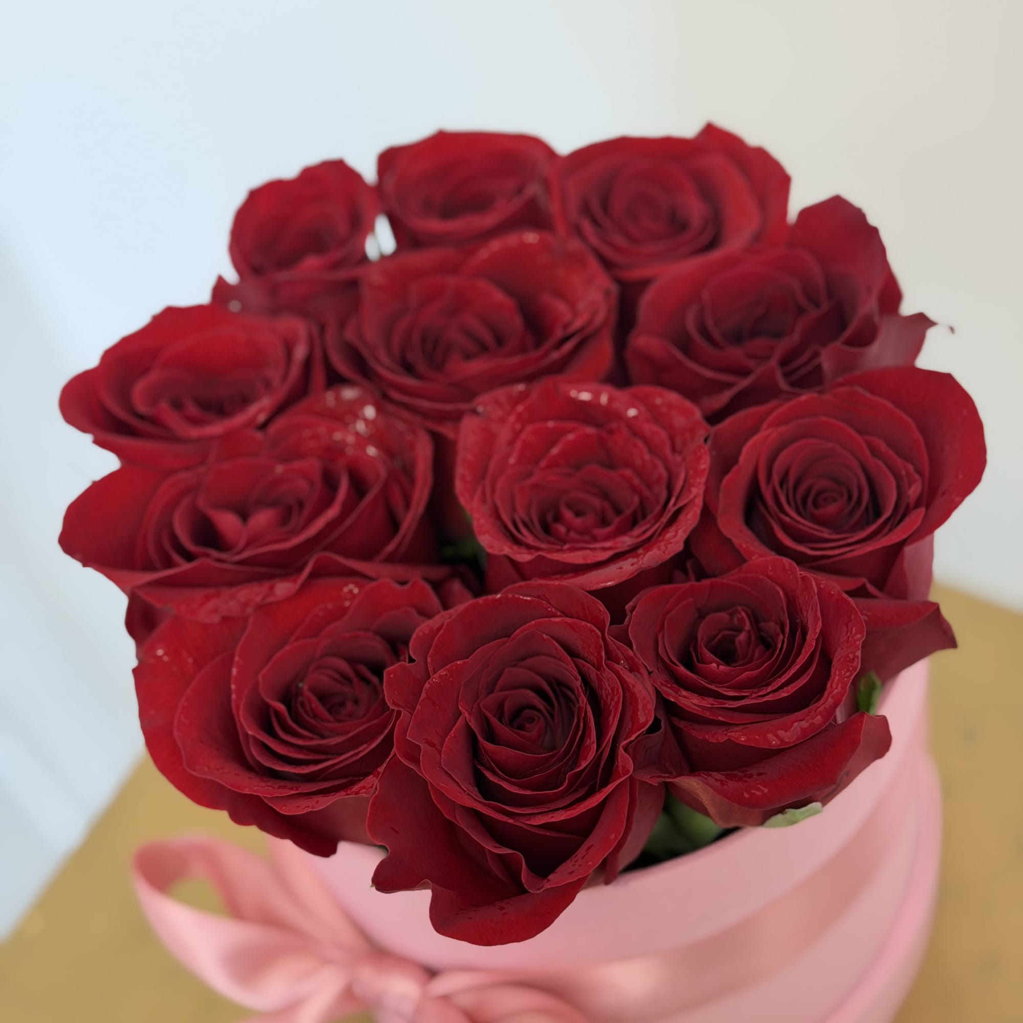 A chic mini box featuring 12 premium Ecuadorian red roses, finished with
