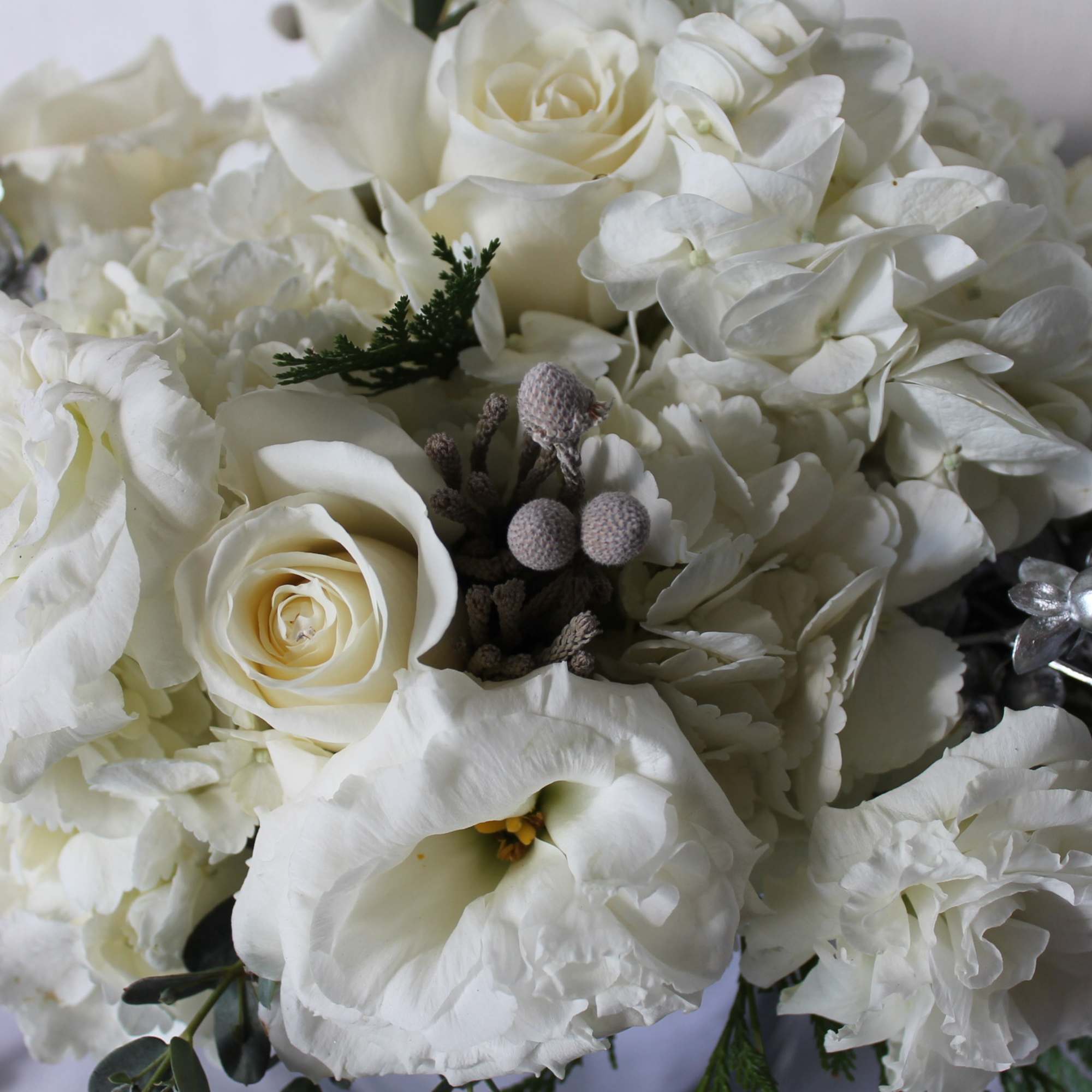 A mix of premium wintery white blooms with metallic accents will warm