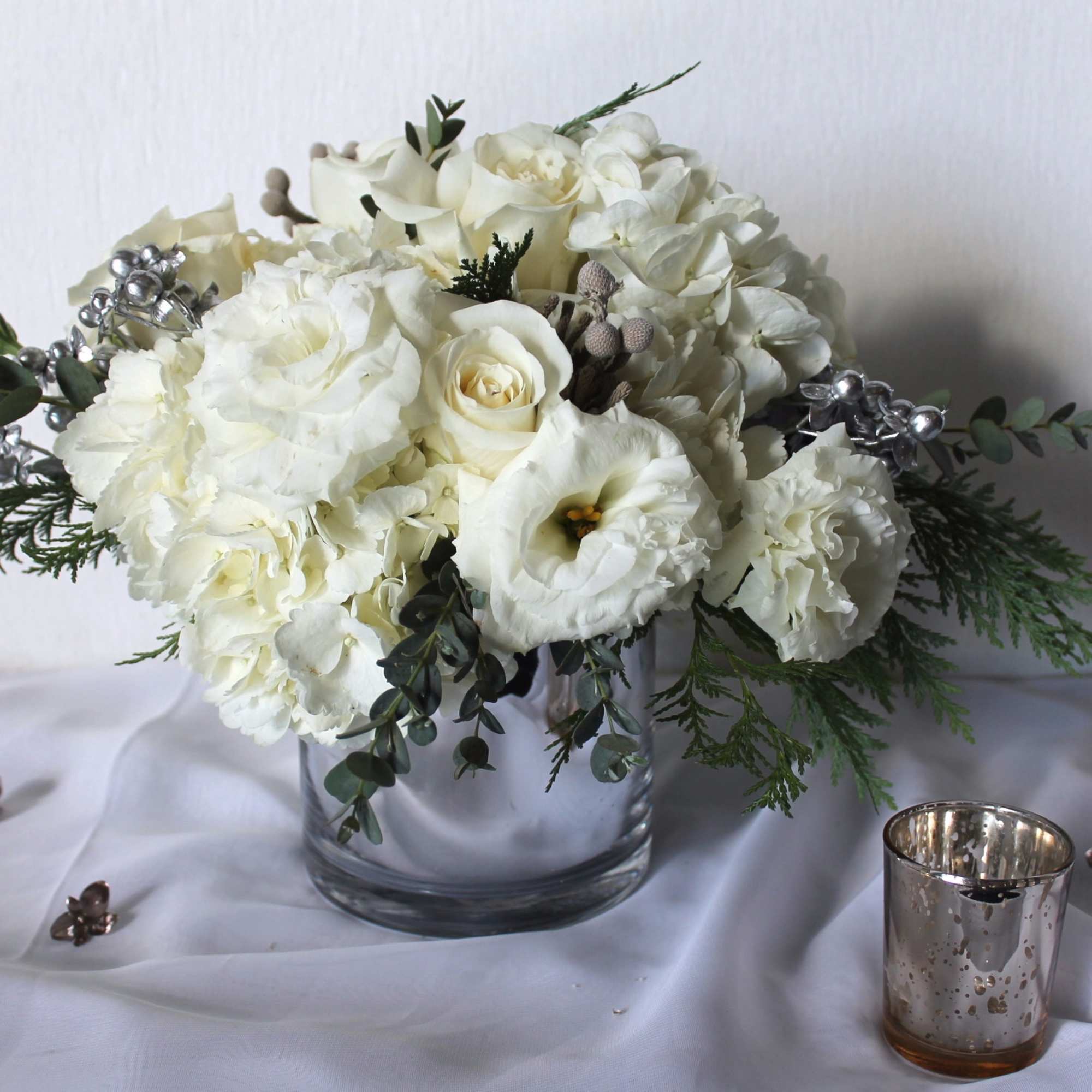 A mix of premium wintery white blooms with metallic accents will warm