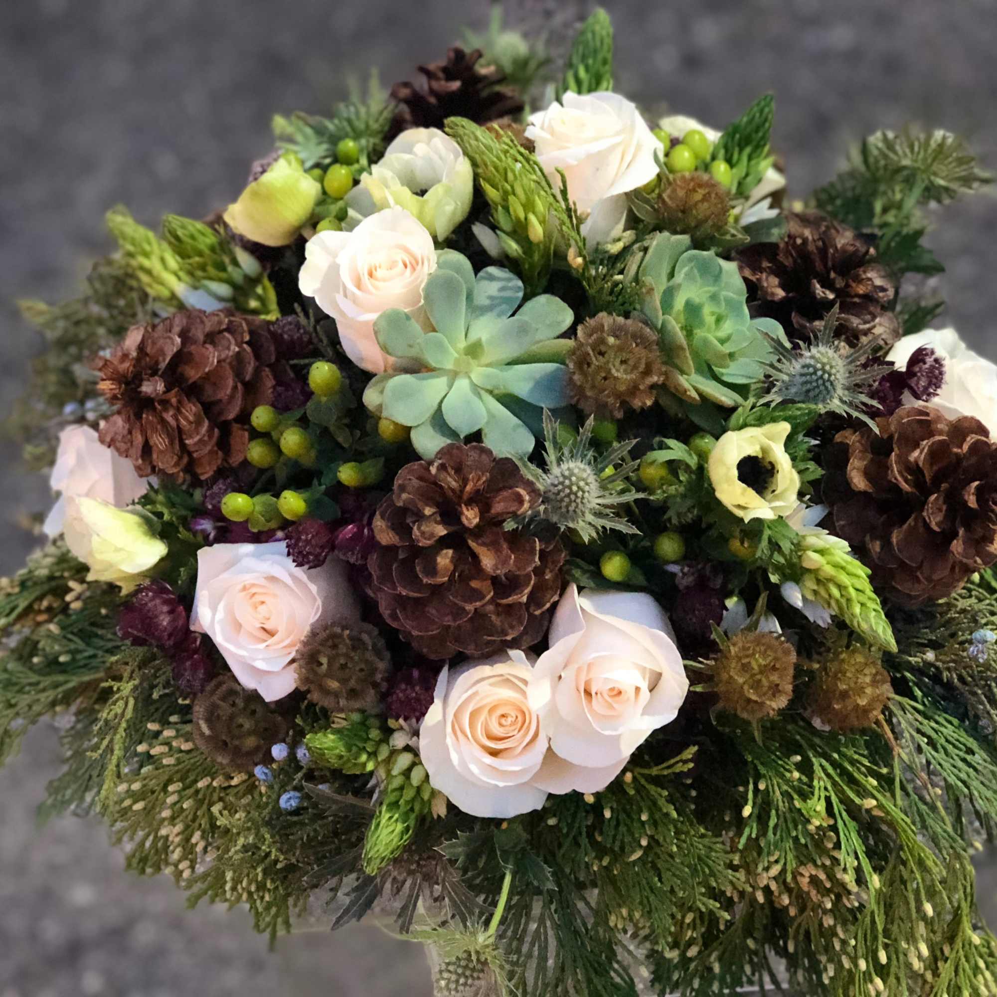 This textural winter arrangement is the perfect centerpiece for your holiday parties.
