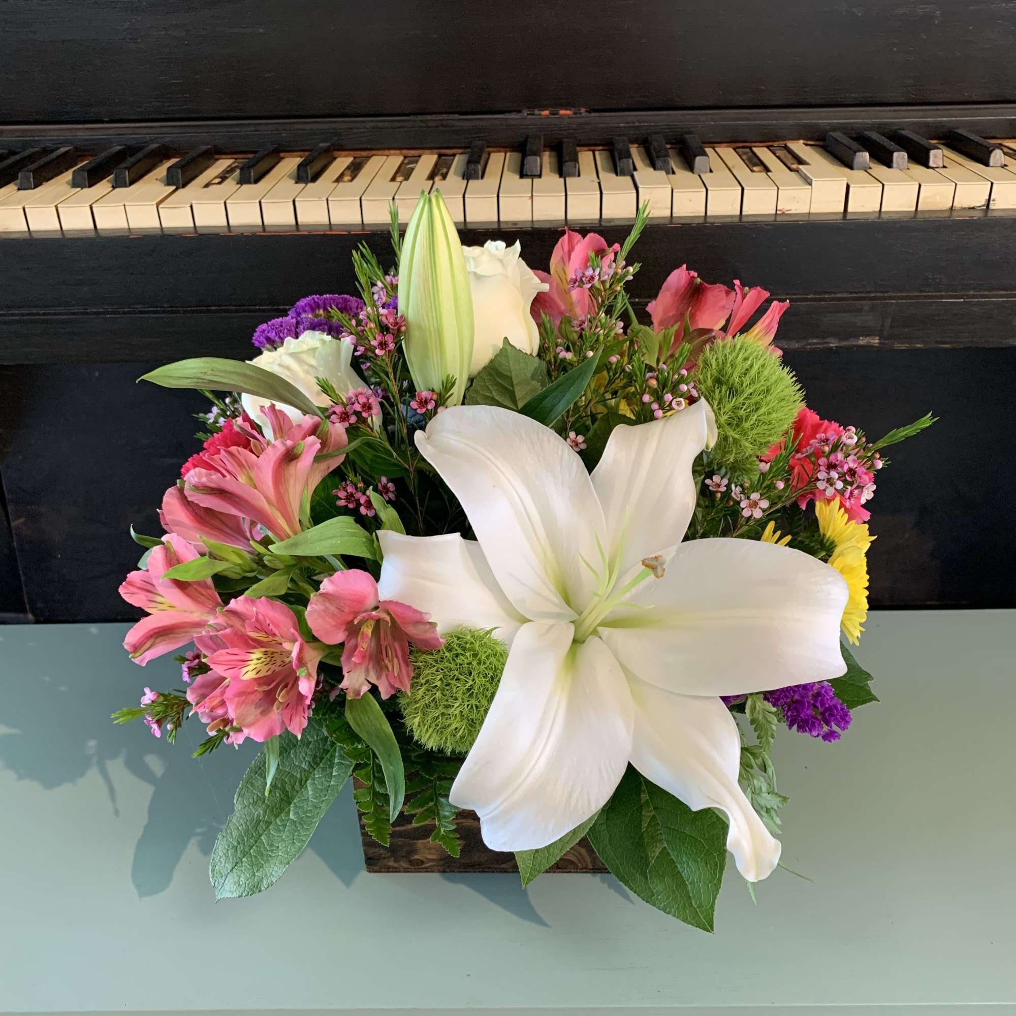 This beautiful arranged flower mix is sure to but a smile on