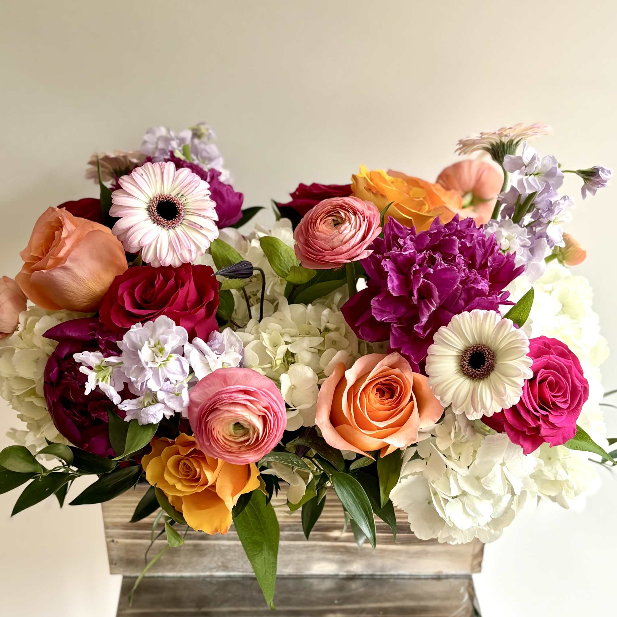 A rich mix of seasonal flowers in variety of bright colors arranged