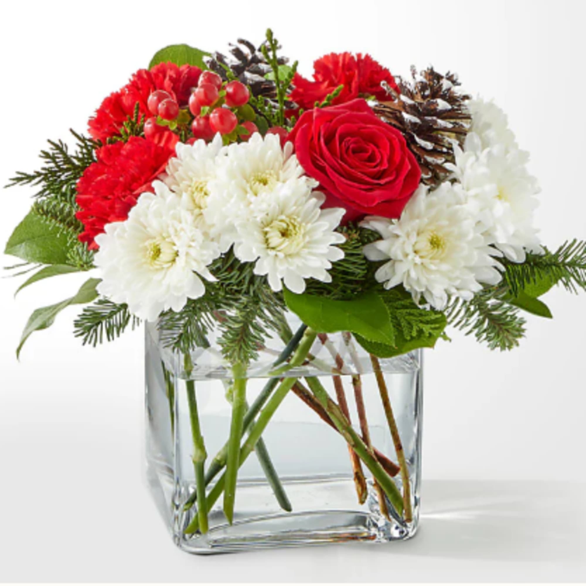 A delicate balance of red and white florals accented with seasonal greens