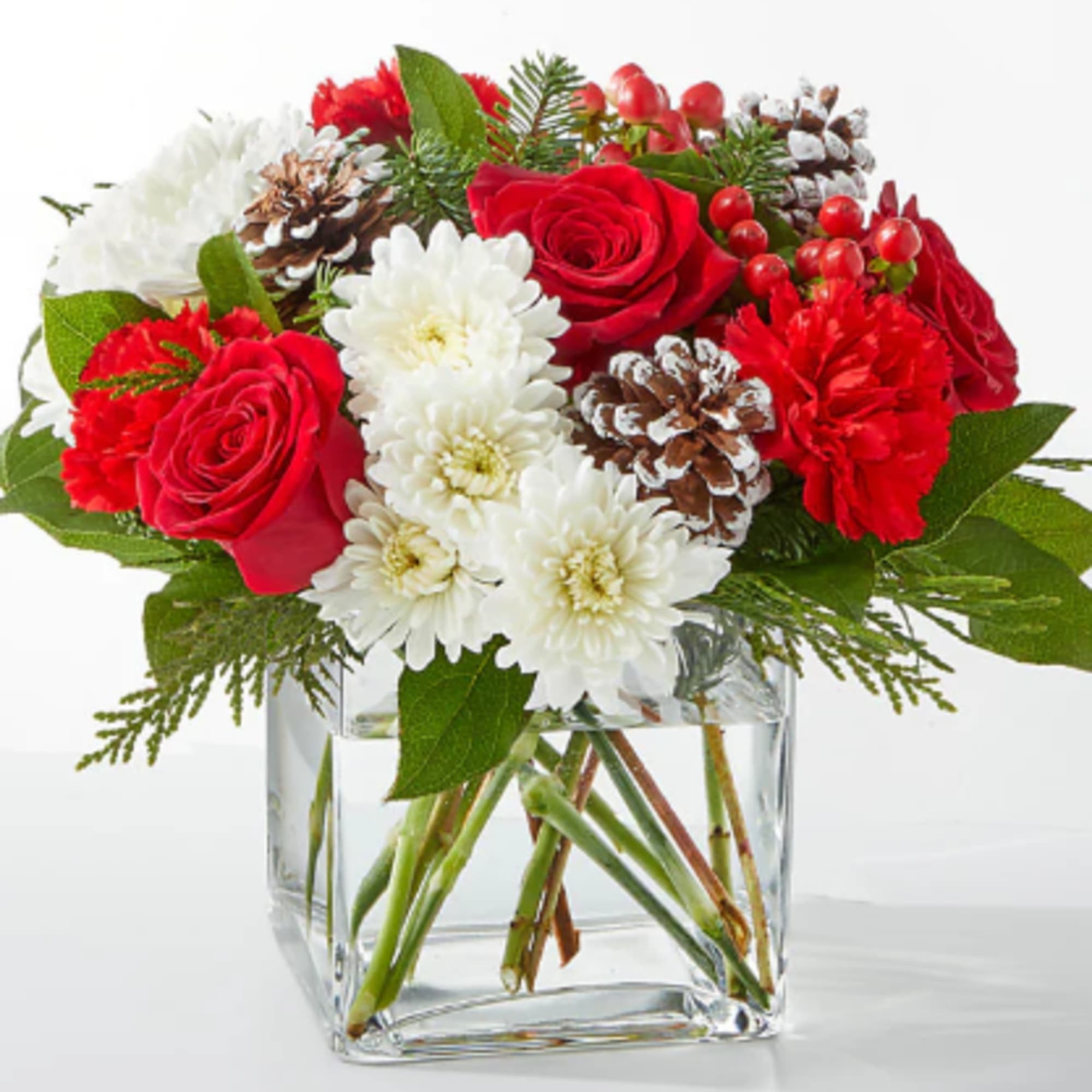 A delicate balance of red and white florals accented with seasonal greens