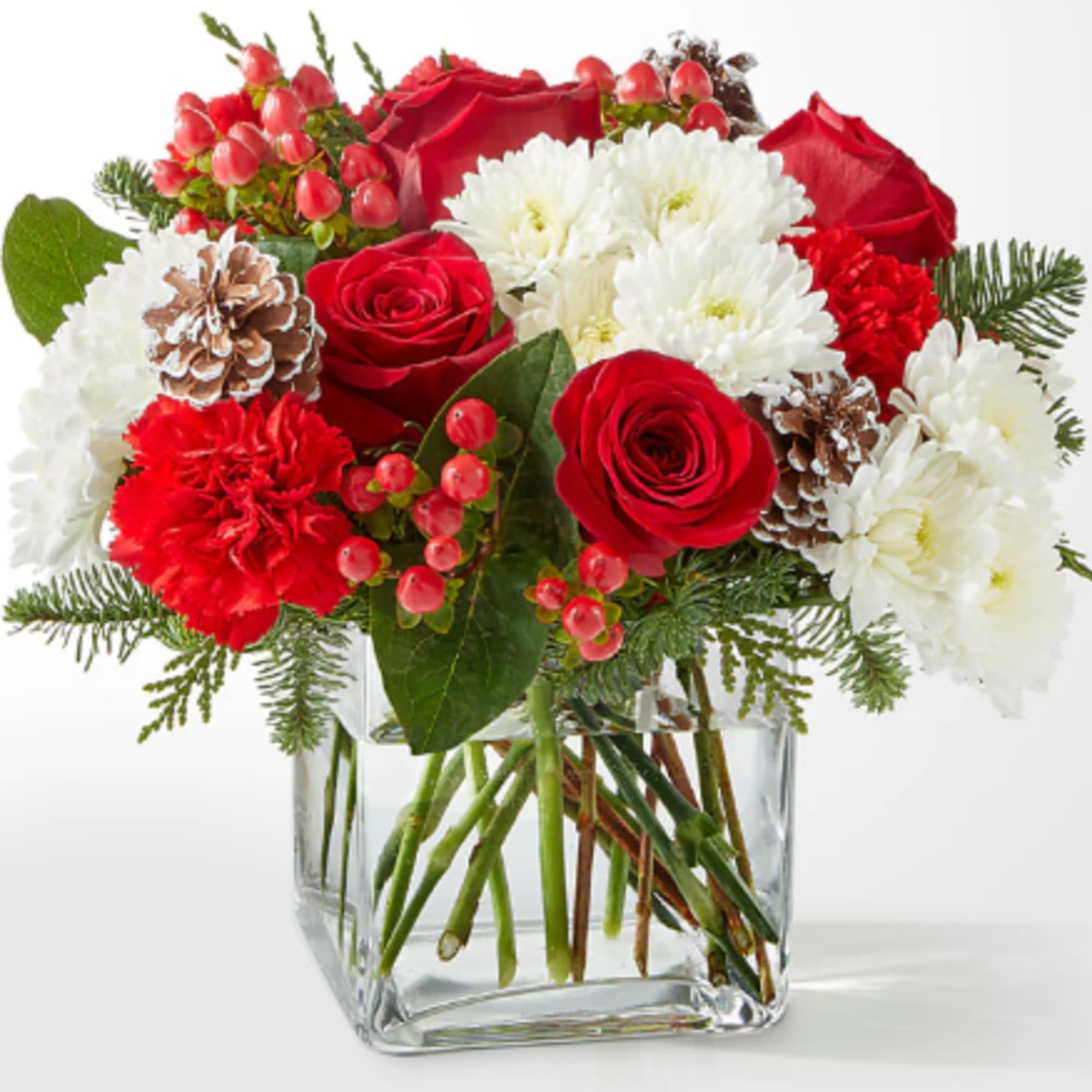 A delicate balance of red and white florals accented with seasonal greens