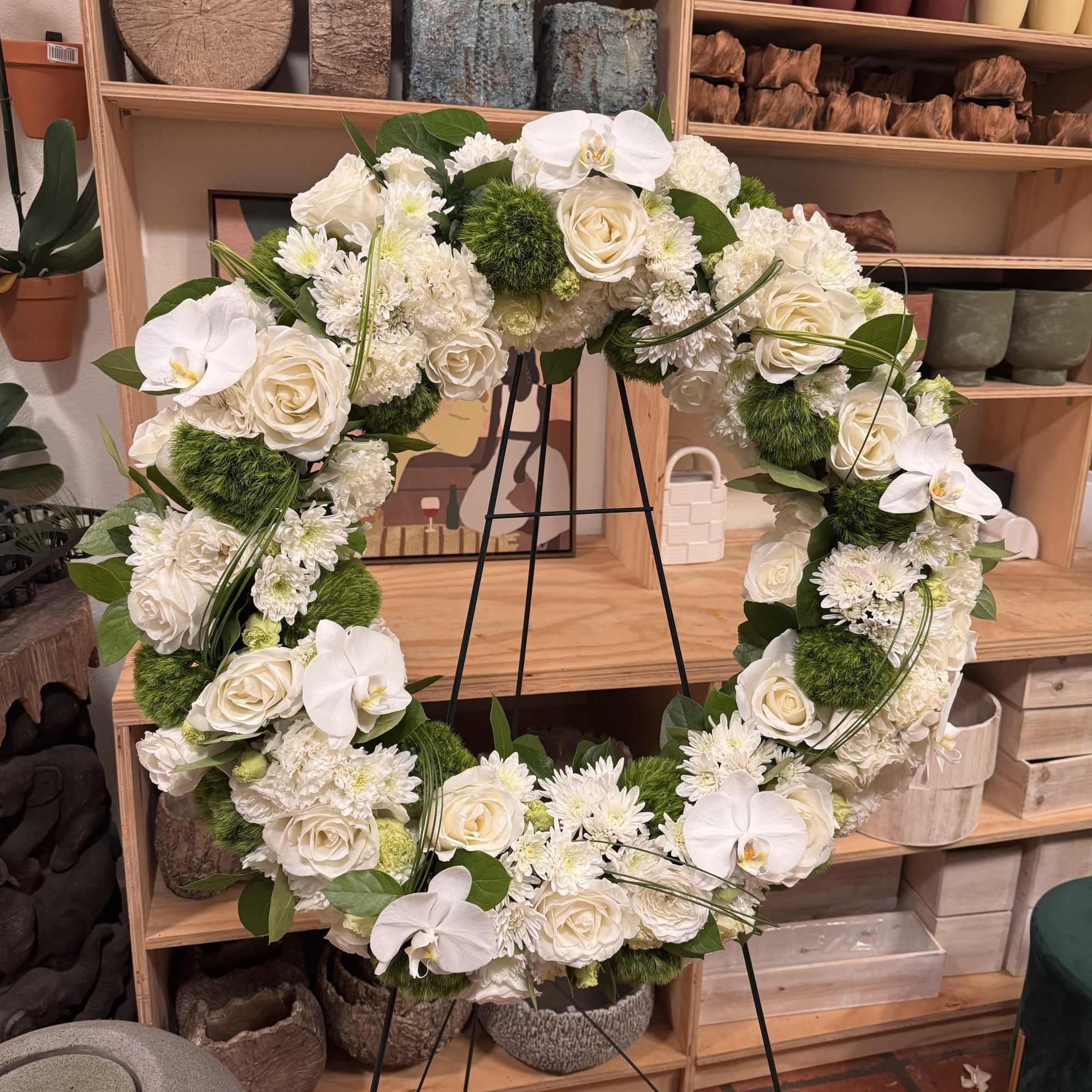 A beautiful white and green tribute wreath that calms, this easel arrangement