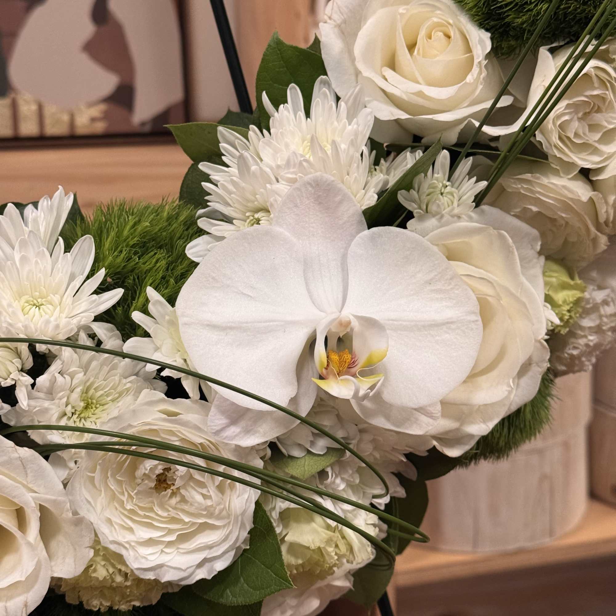 A beautiful white and green tribute wreath that calms, this easel arrangement
