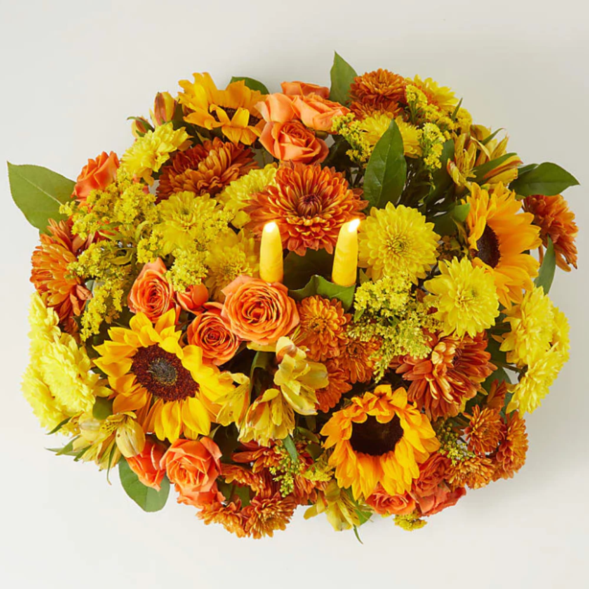 Enjoy a candlelit dinner with this colorful arrangement that embraces every shade