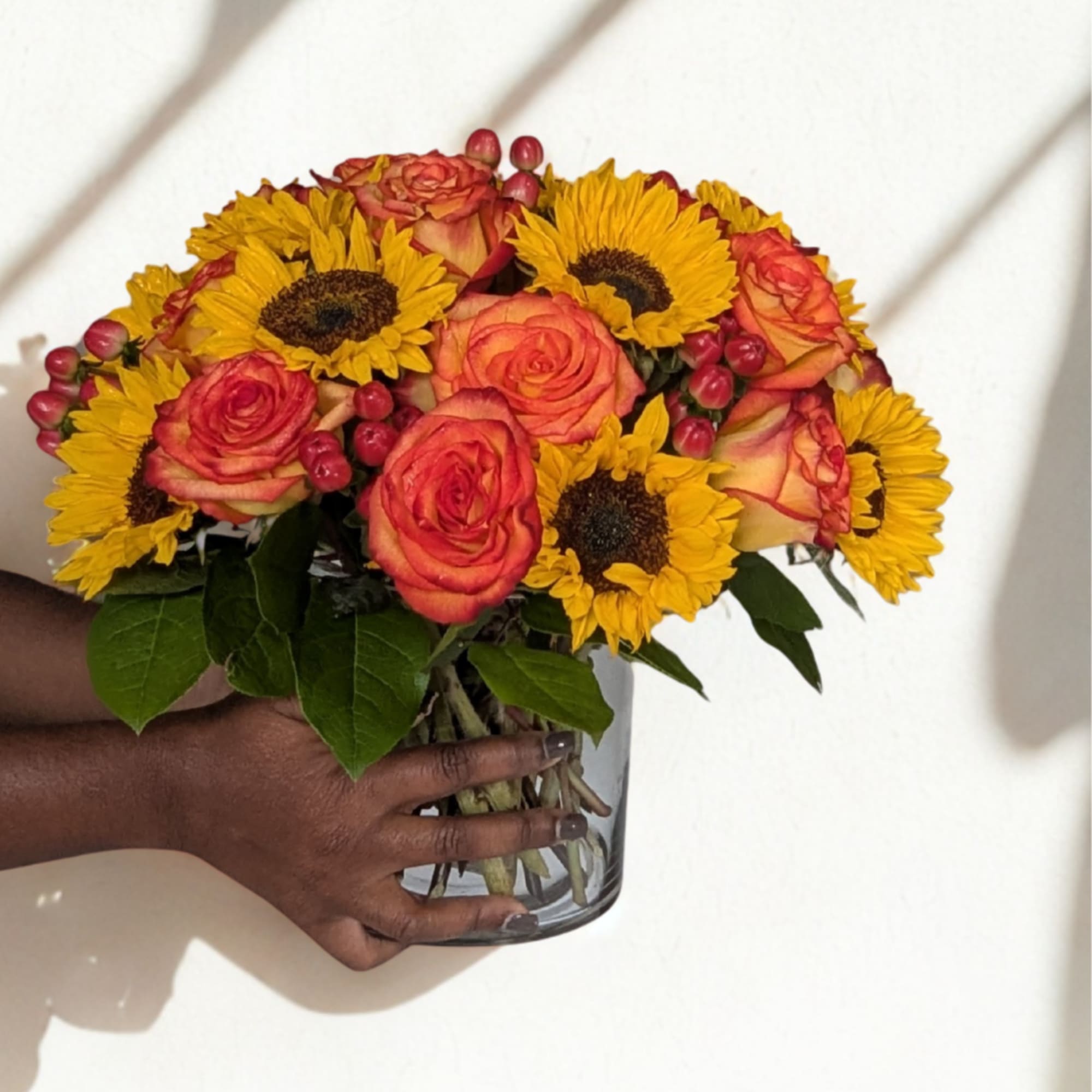 A stunning seasonal favorite! Golden sunflowers and radiant orange roses are paired