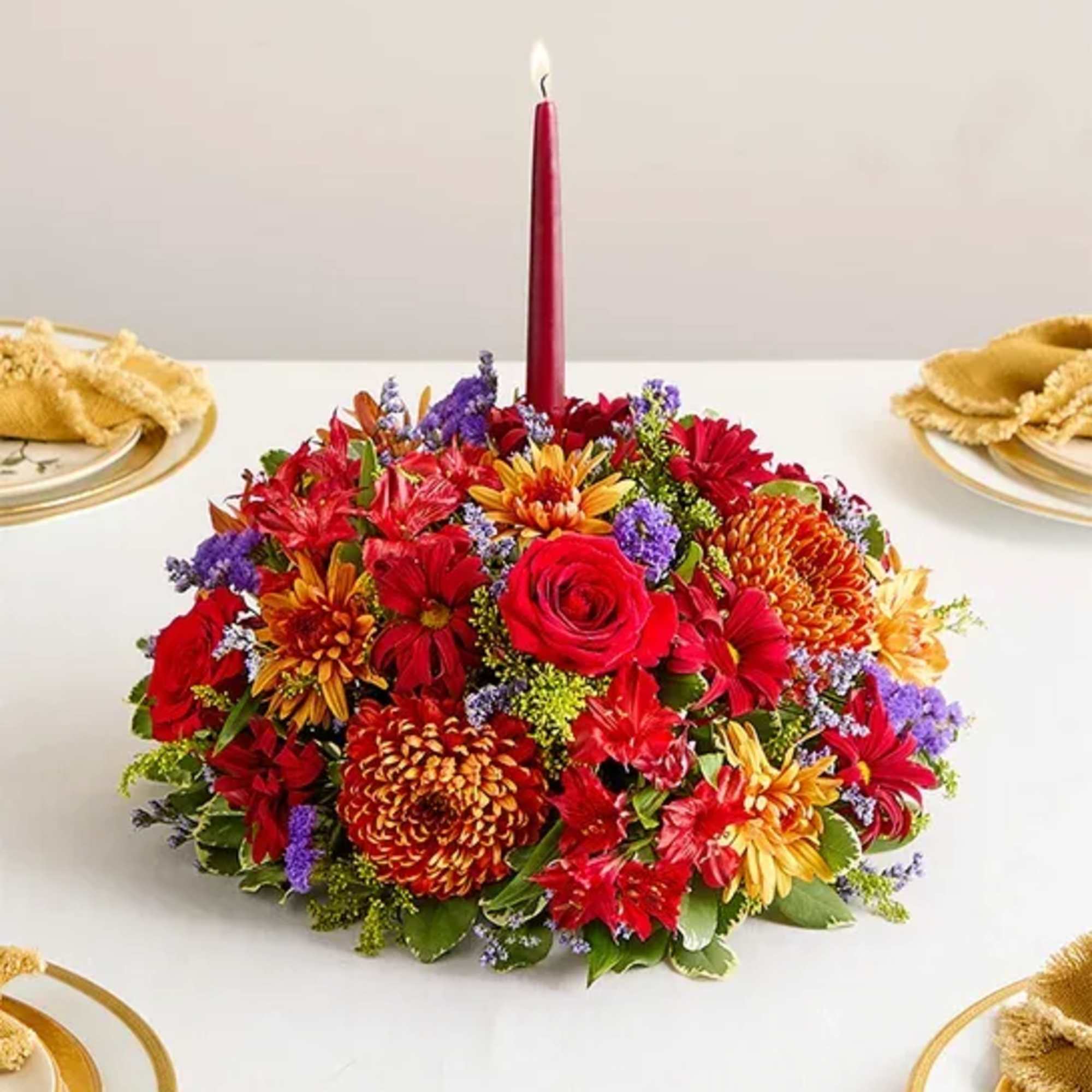 All-around centerpiece arrangement with red roses, Peruvian lilies (alstroemerias), and daisy poms;