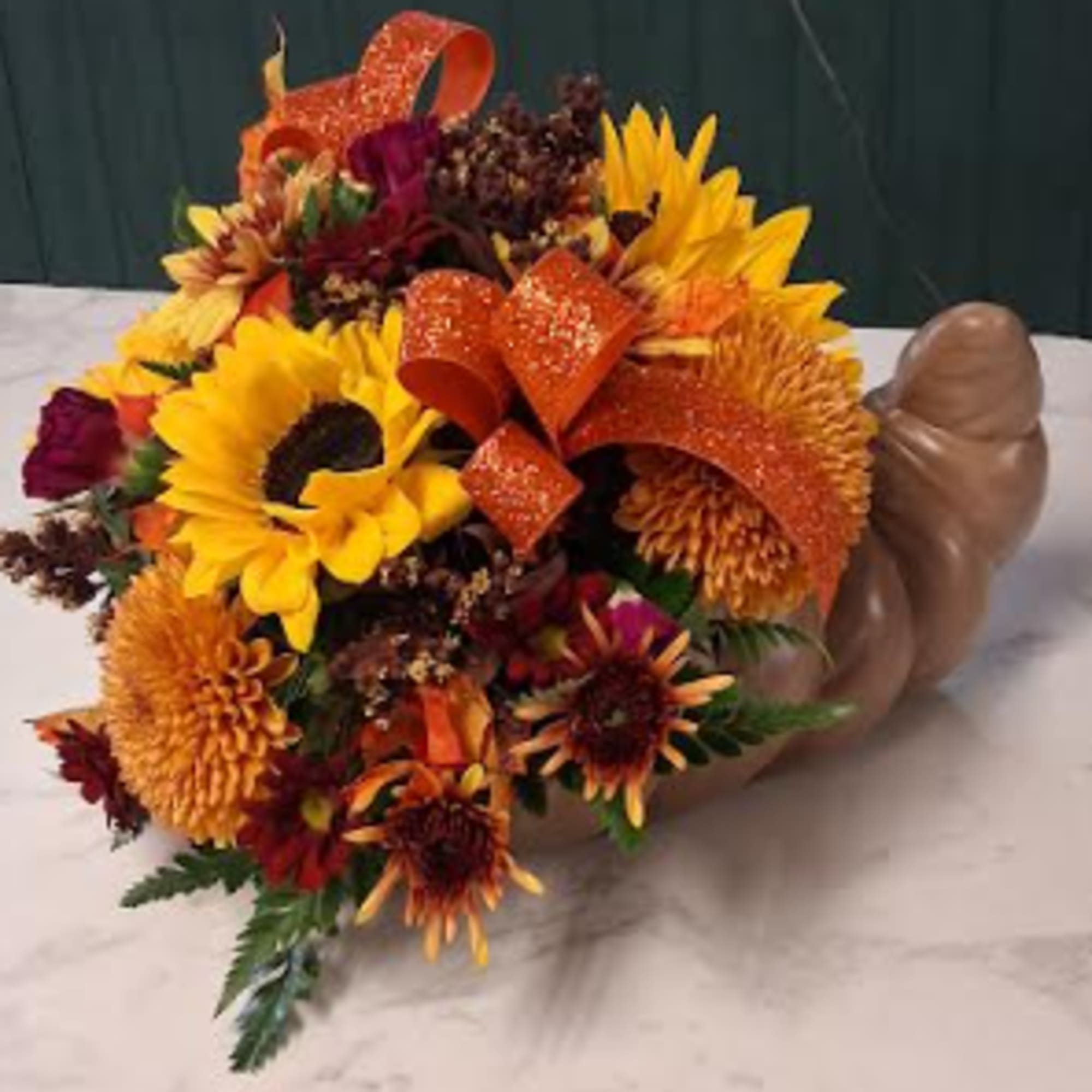 Celebrate the beauty of the season with this stunning arrangement designed in