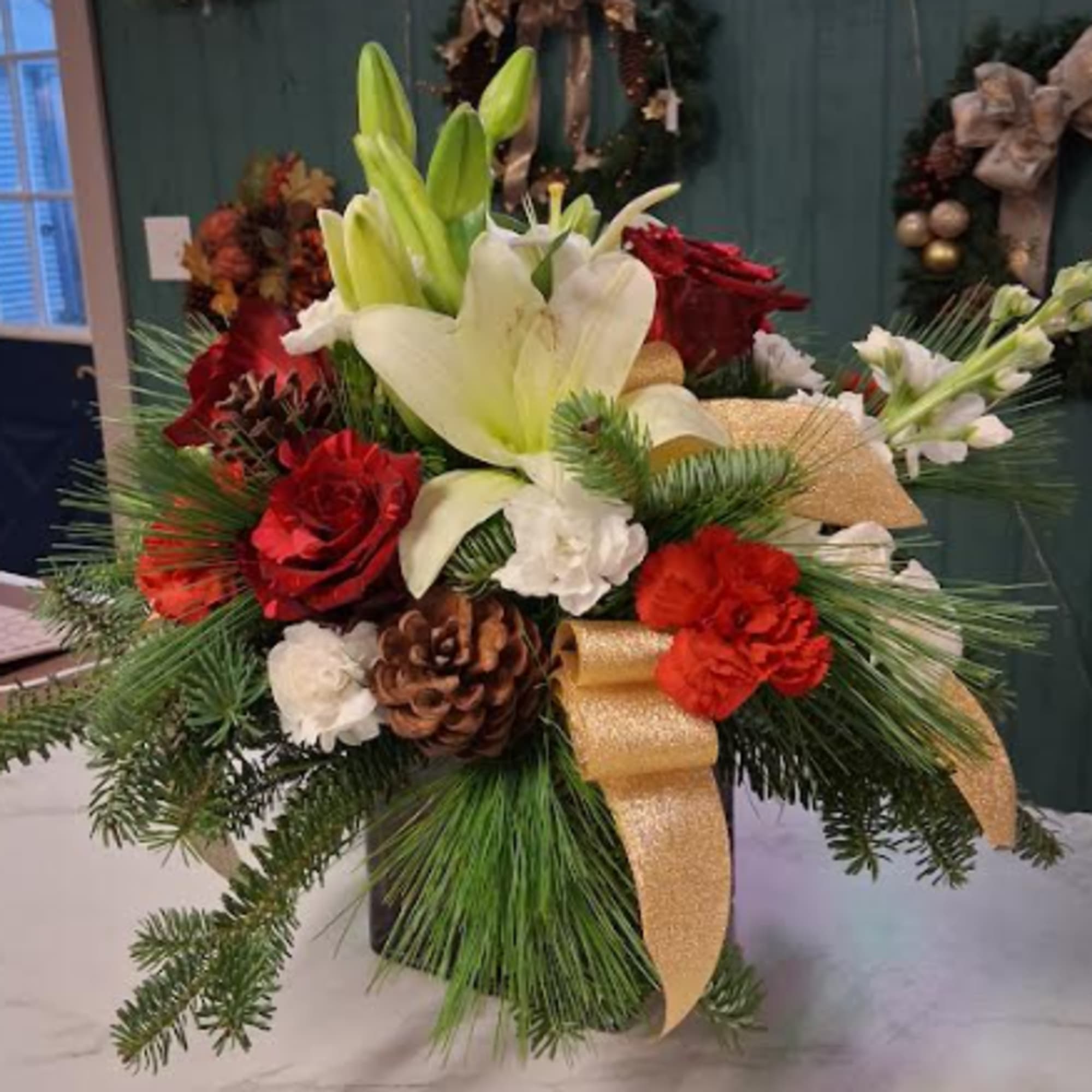 Designed in a striking red cube, this sophisticated Christmas arrangement brings timeless