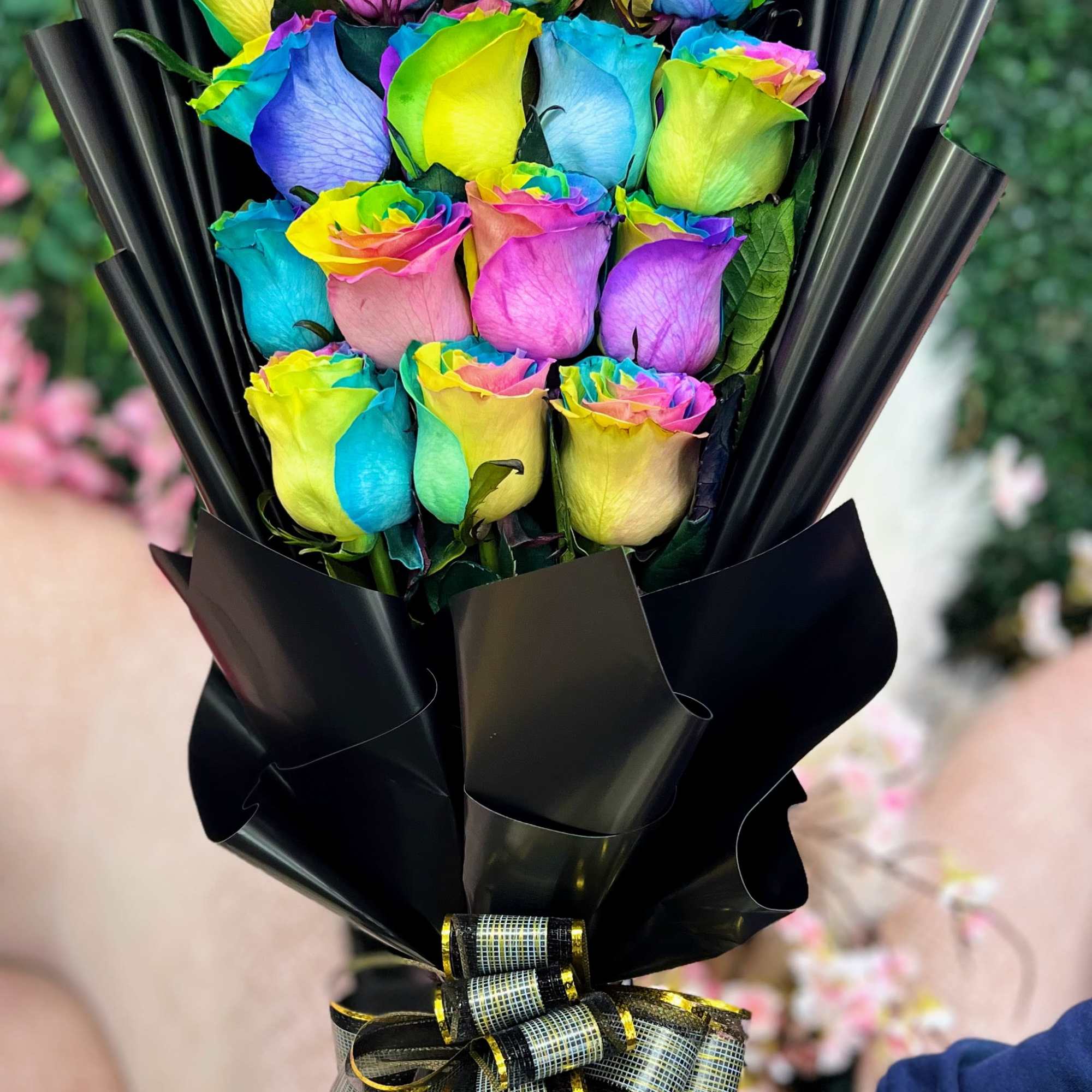 Brighten any moment with this vibrant Wrapped Rainbow Rose Bouquet. Each rose
