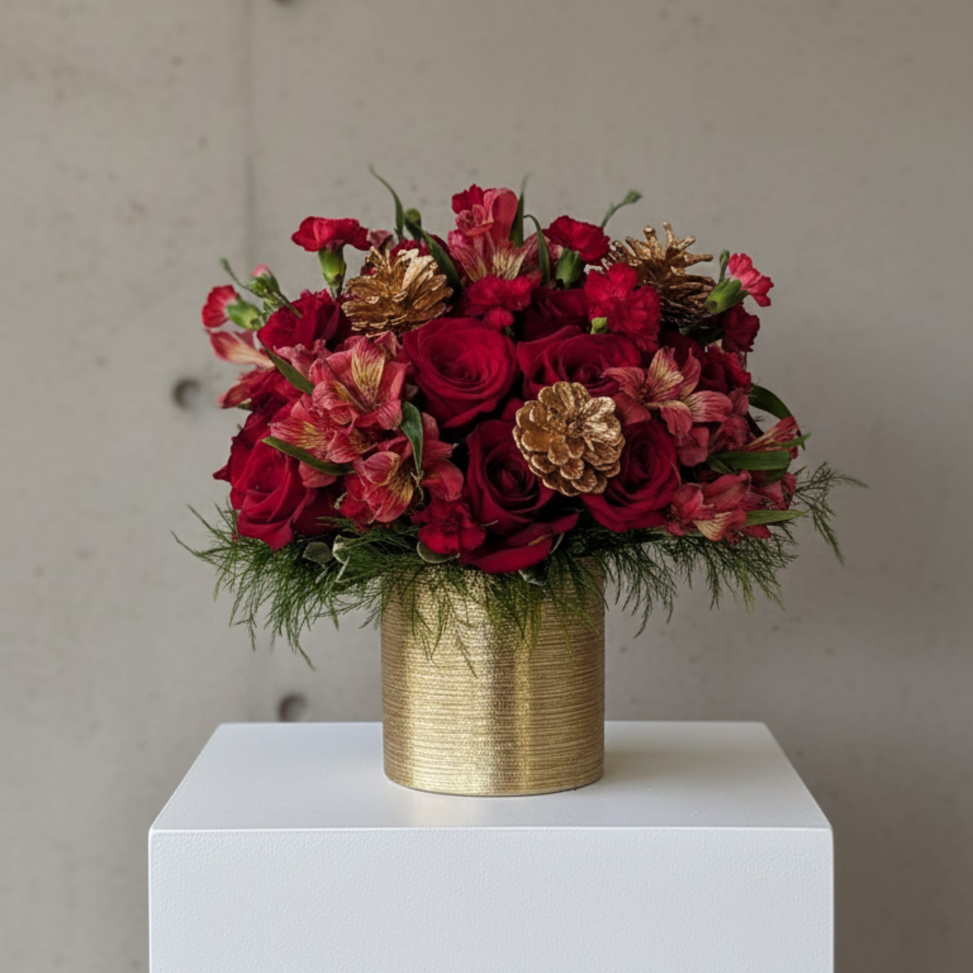 A timeless holiday arrangement that radiates warmth and sophistication. Featuring lush red