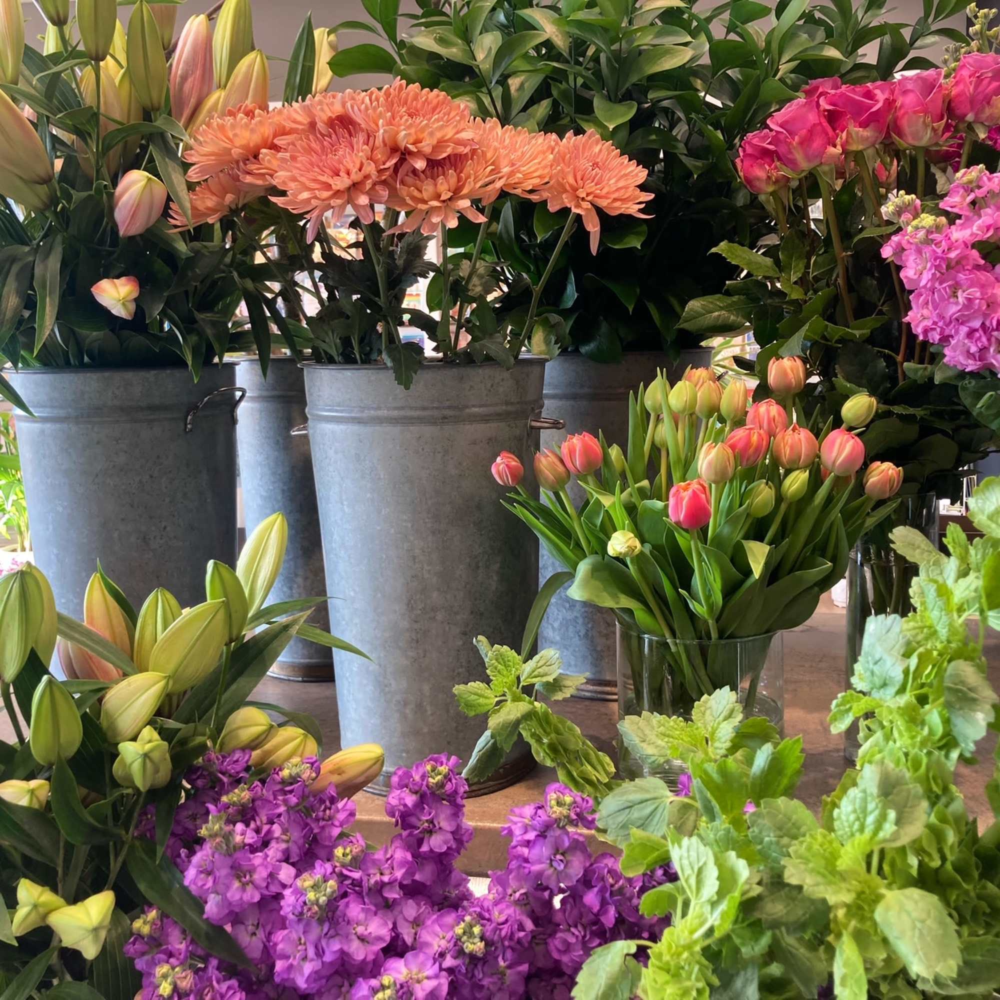 The freshest flowers and greens of the season are artfully arranged by