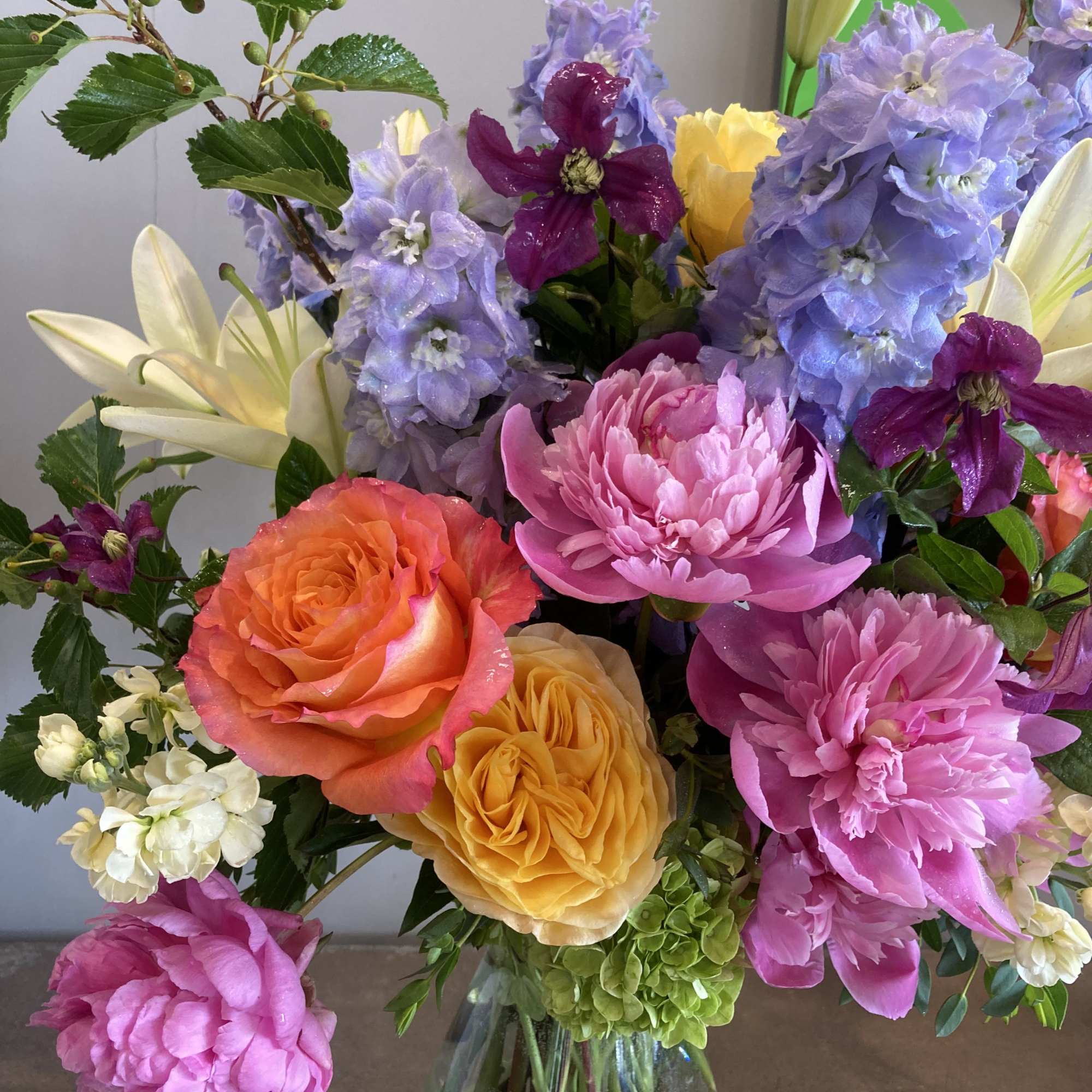 The freshest flowers and greens of the season are artfully arranged by