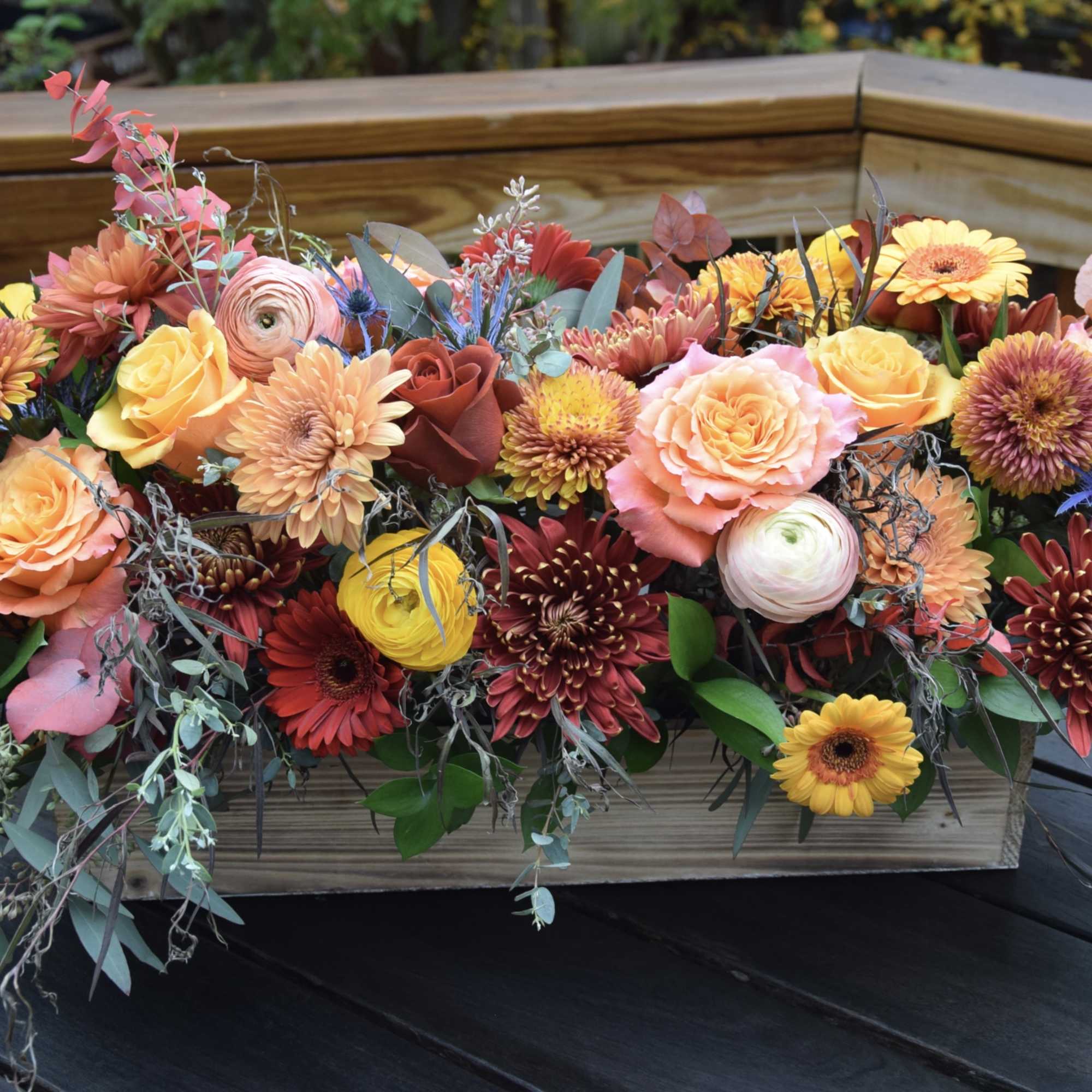 Thanksgiving flower centerpiece with premium seasonal flowers and greenery arranged in a