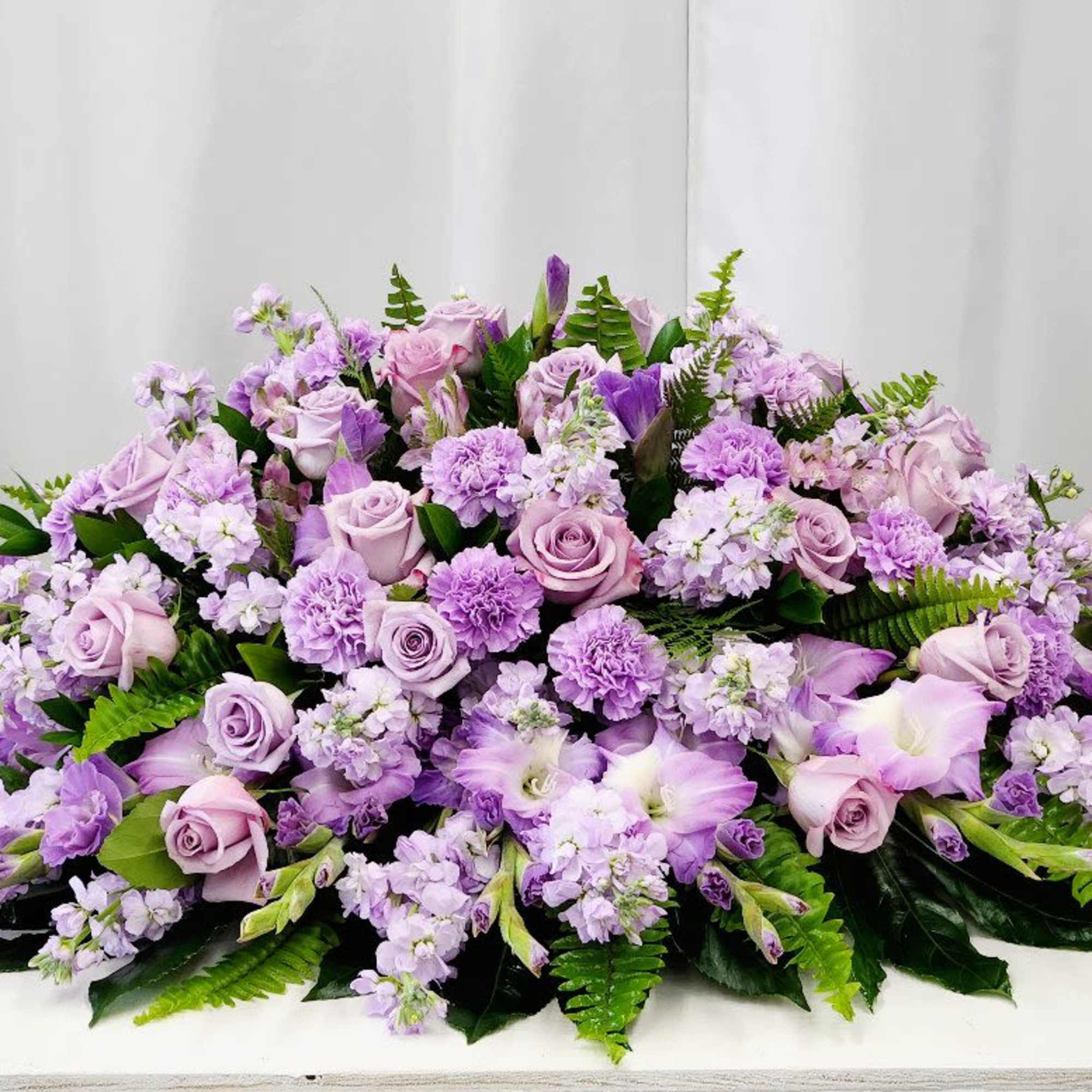 The Loving Recollection Casket Spray offers a gentle and elegant tribute, beautifully
