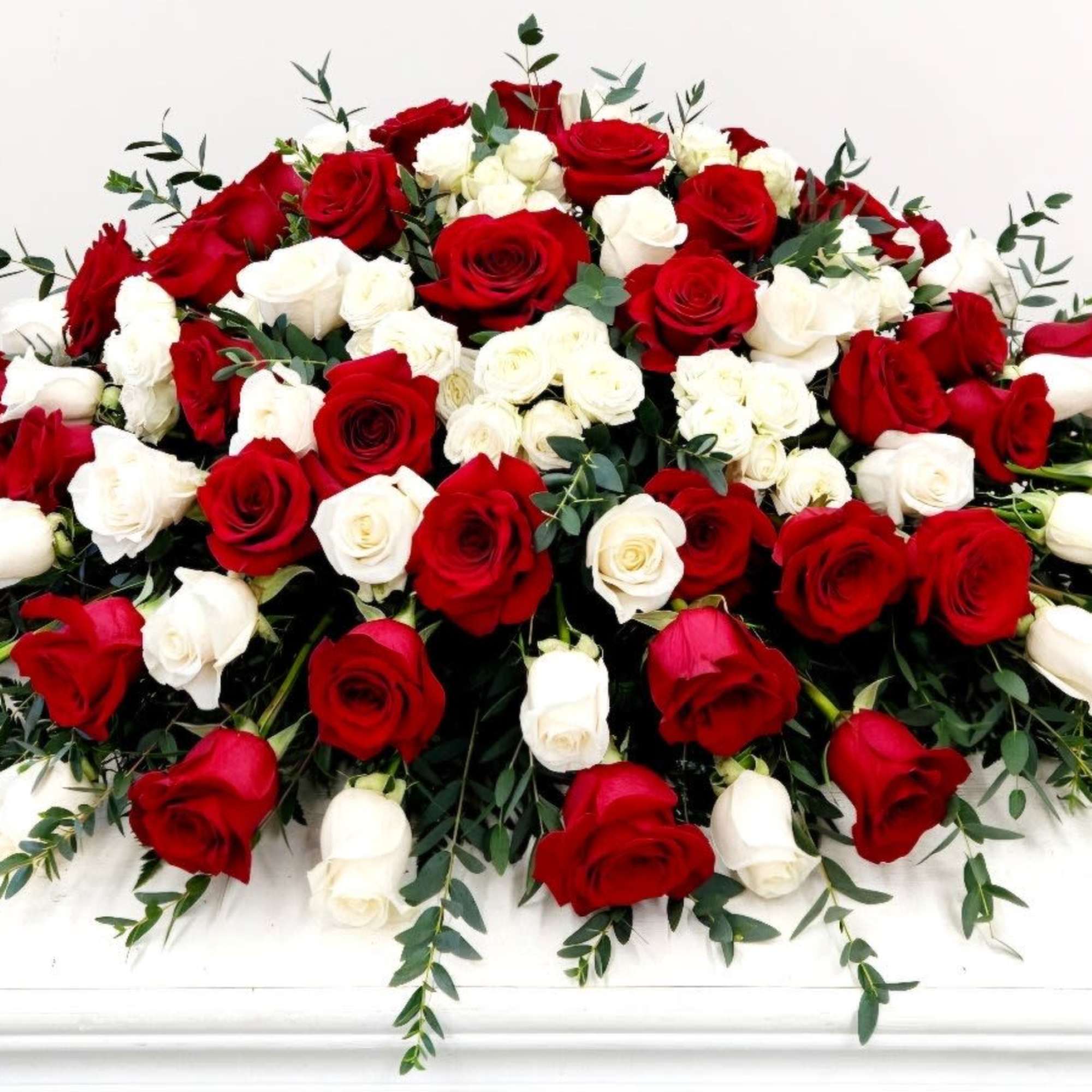 The Peaceful Rest Casket Spray offers a graceful tribute, capturing the essence