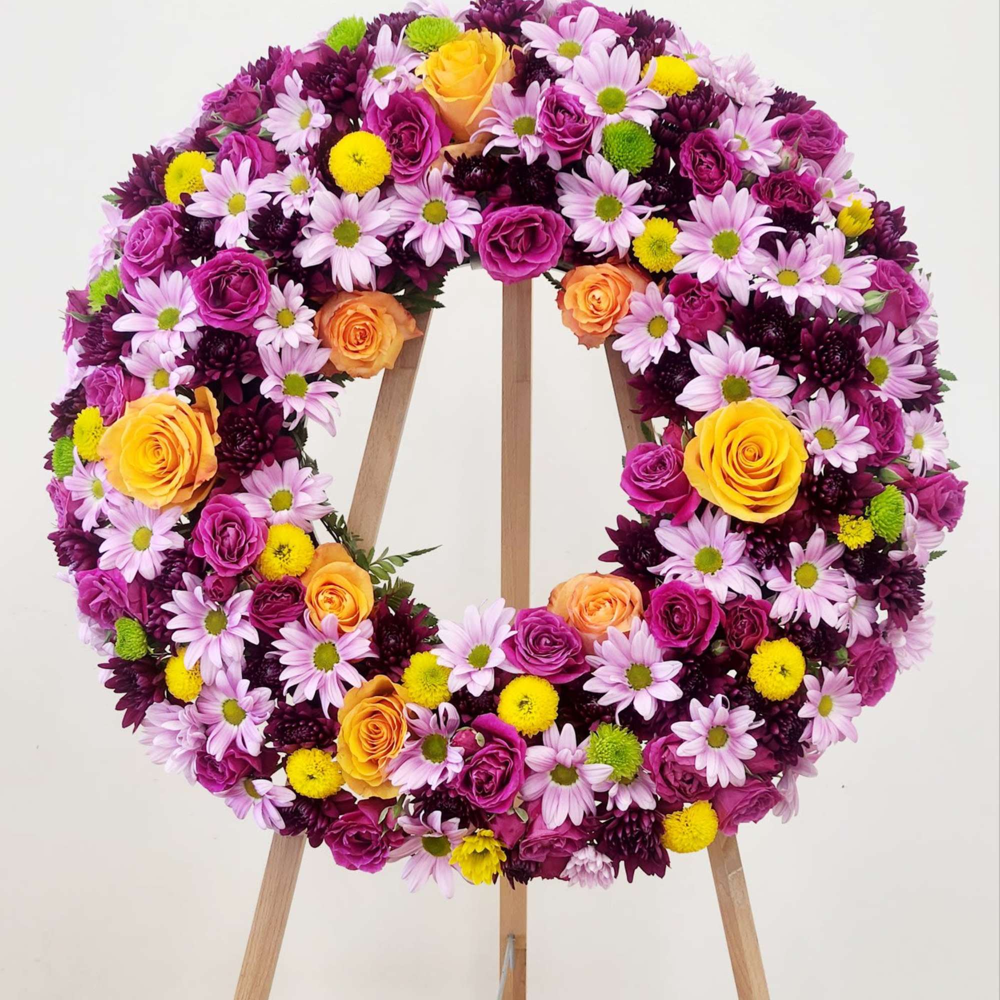 The Celebrating You Wreath offers a vibrant yet gentle tribute, combining elegant