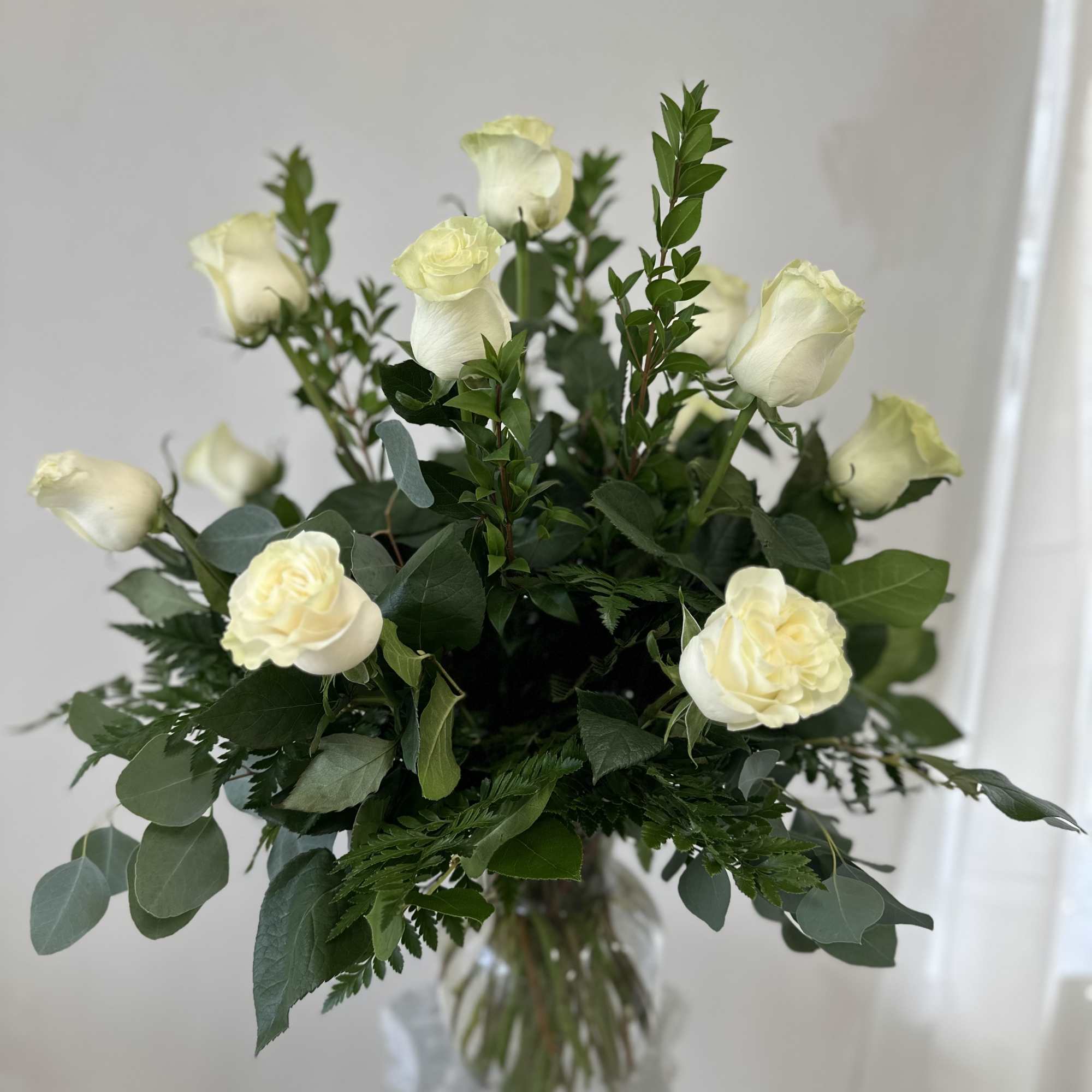 Elevate your expression of sympathy and remembrance with the One Dozen Long