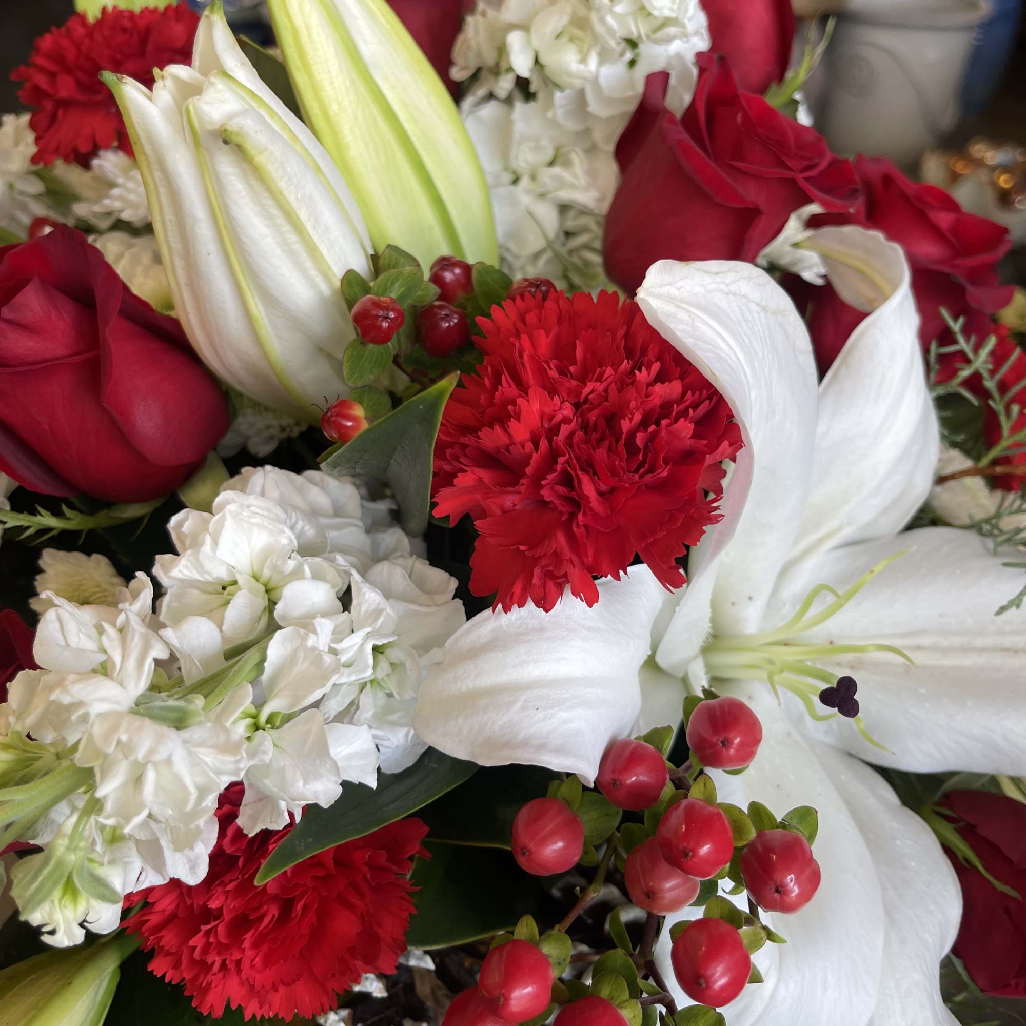 A beautiful 6&quot; glass cube container filled with traditional Christmas flowers &amp;