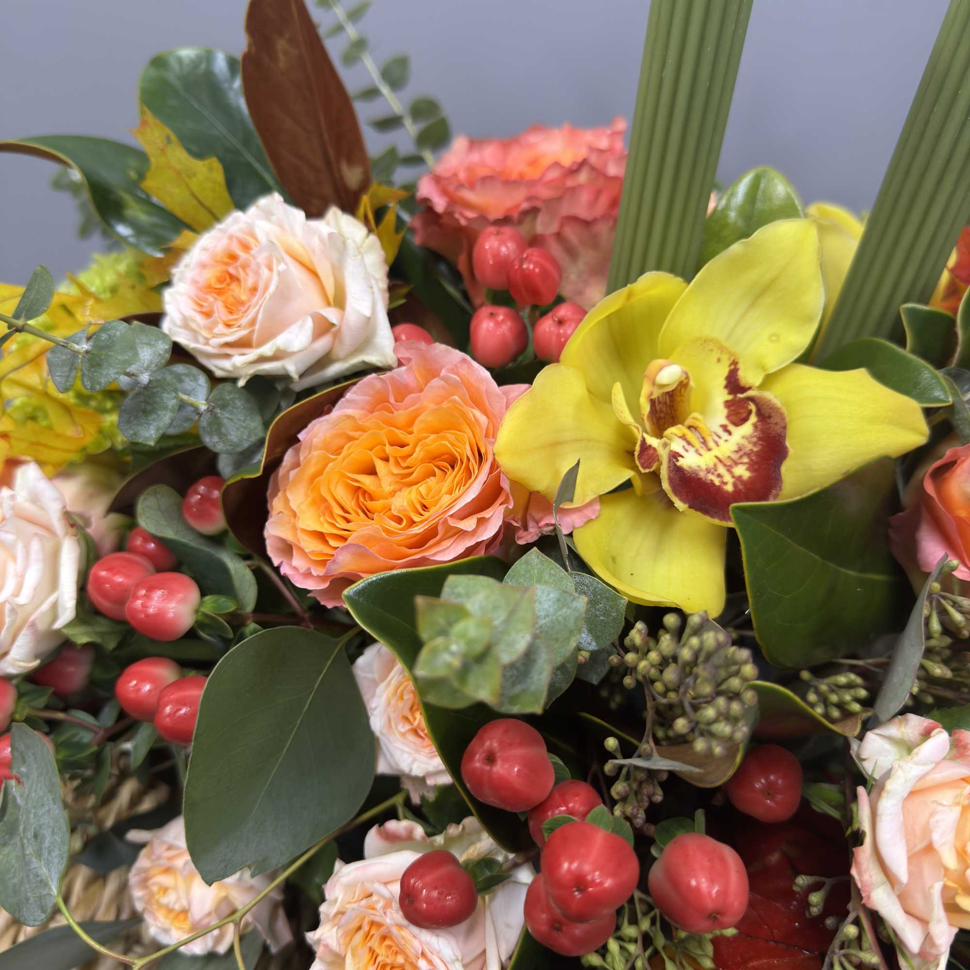 This long and low centerpiece features elegant olive-green candles paired with seasonal