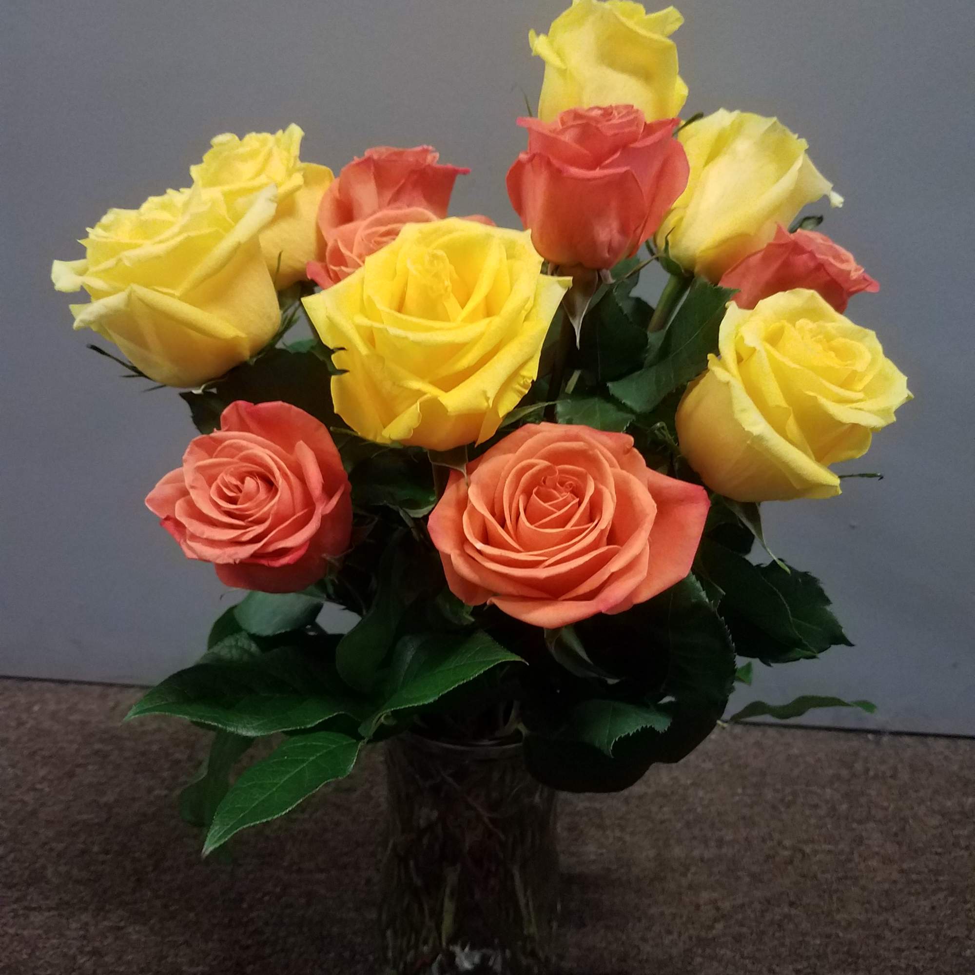 Bright colors of orange and yellow shine in this rose bouquet like