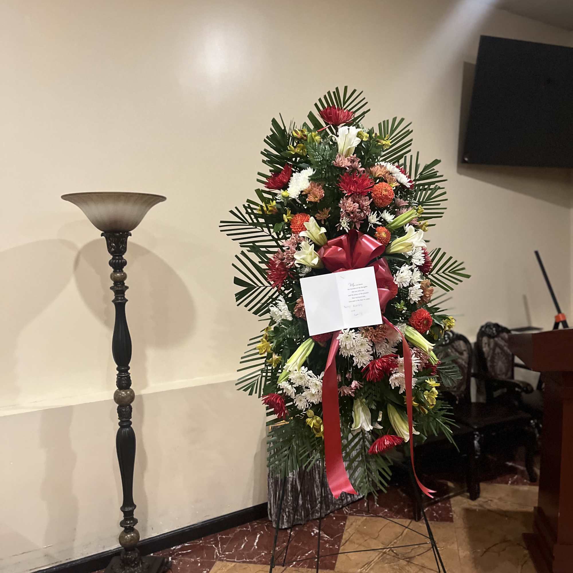 Bright, beautiful, and thoughtfully arranged, this standing spray showcases a stunning mix