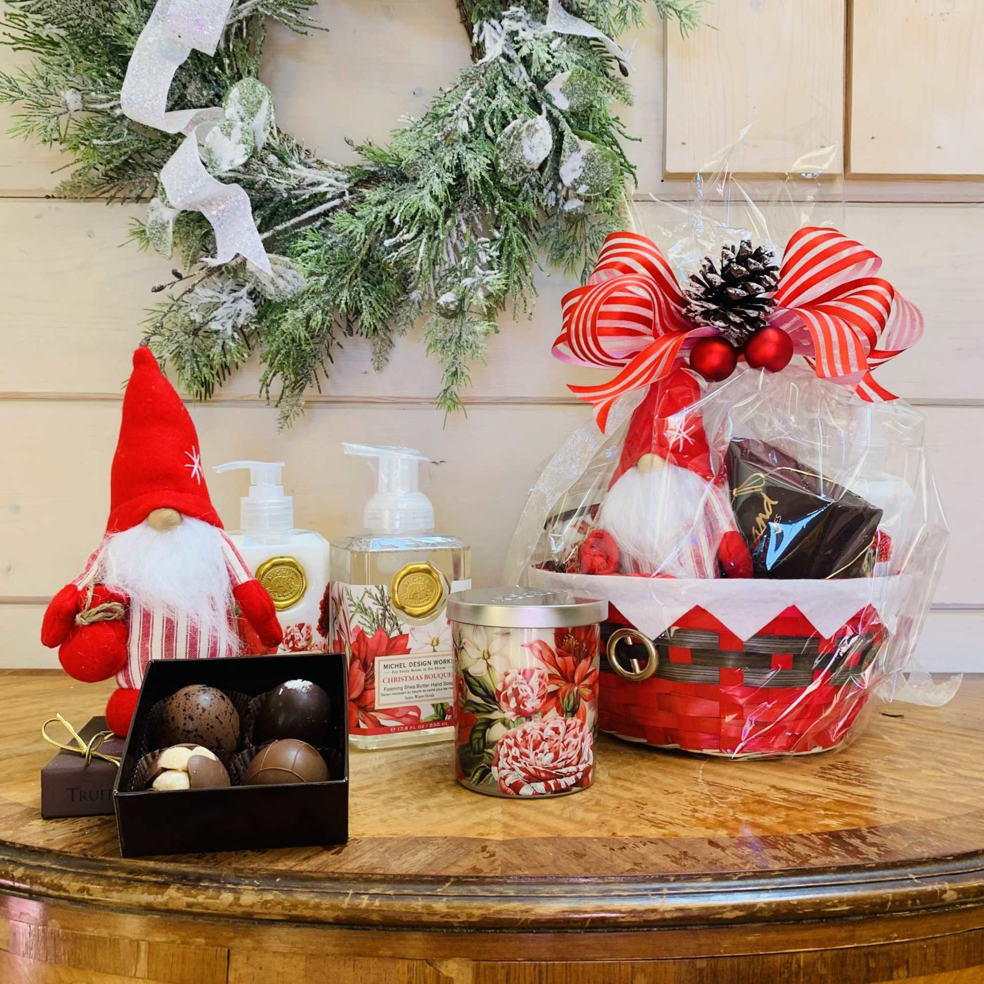 This deluxe Christmas Bouquet gift basket includes a gnome, a four piece
