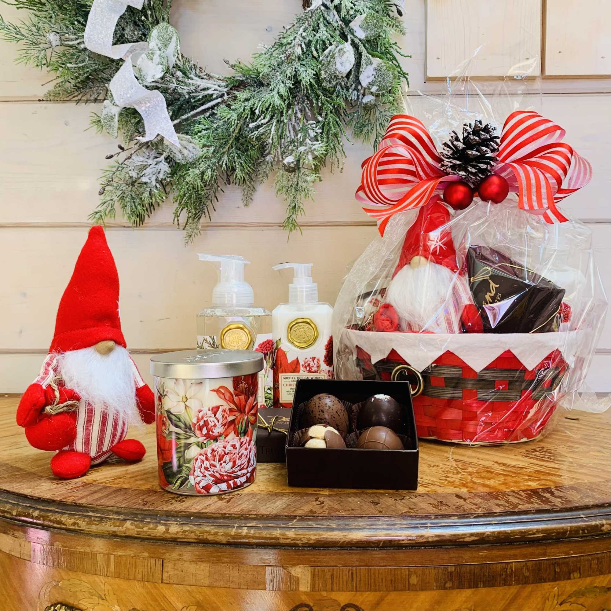 This deluxe Christmas Bouquet gift basket includes a gnome, a four piece