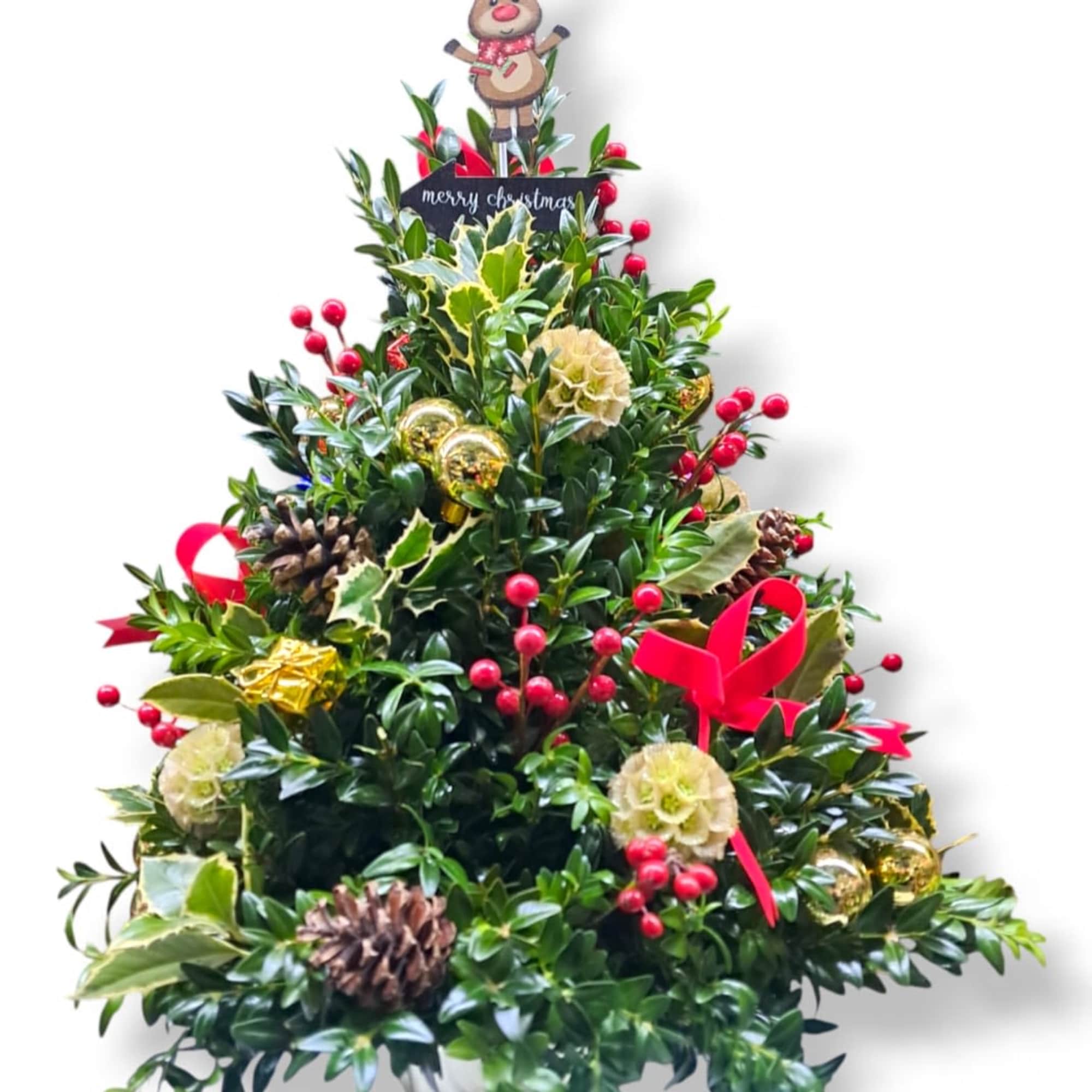 This festive mini tree is adorned with ornaments, bows, pinecones, holly, and