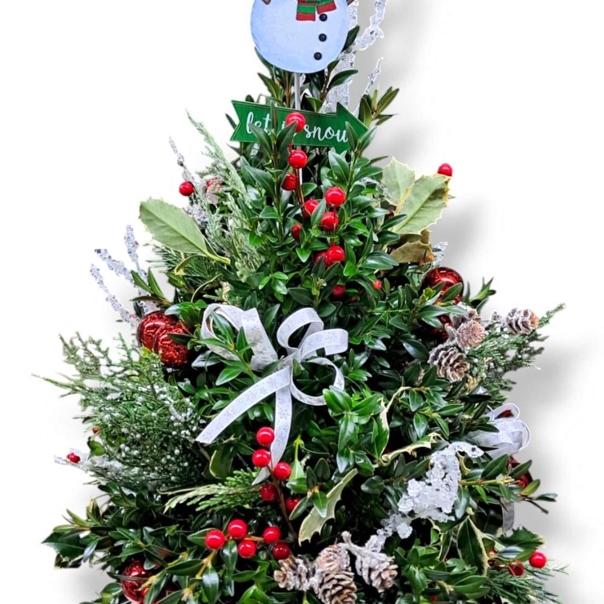 This mini tree is adorned with artificial berries, holly, ornaments, bows and