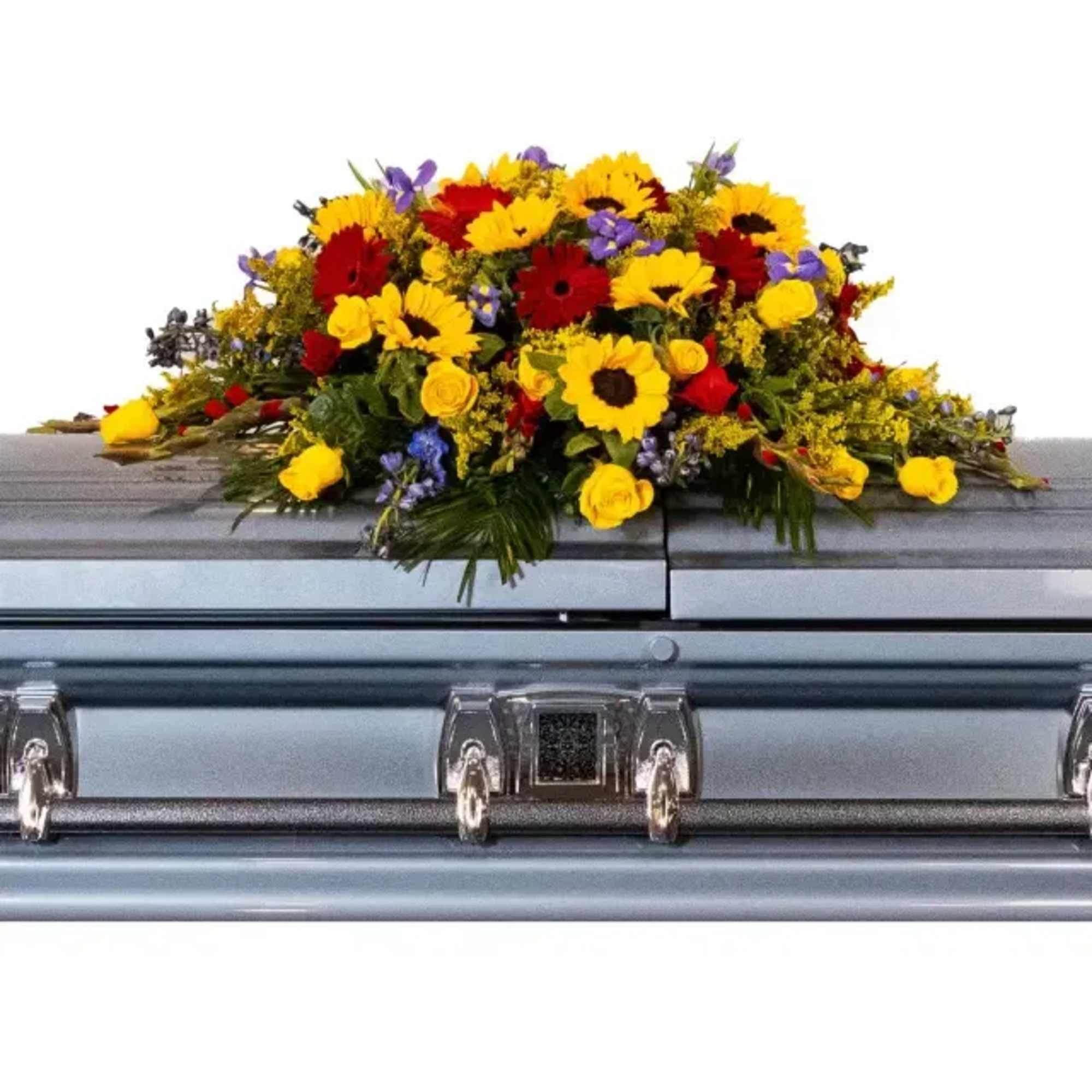 A vibrant casket spray featuring yellow, red, and blue fresh flowers.