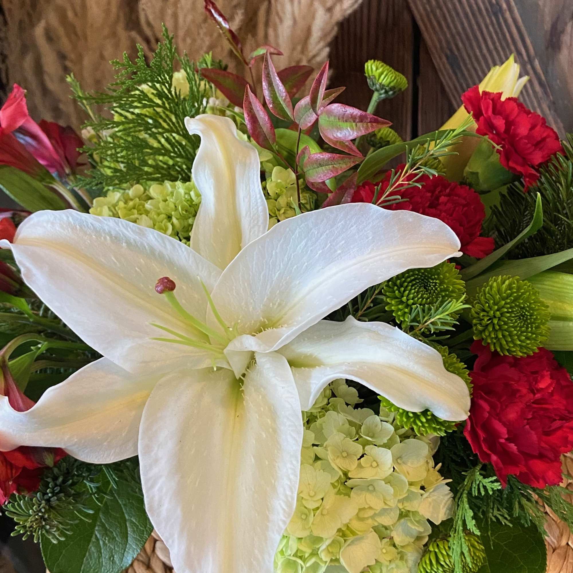 Assortment of Winter Flowers Arranged in a Unique Birch Pot.  Sure