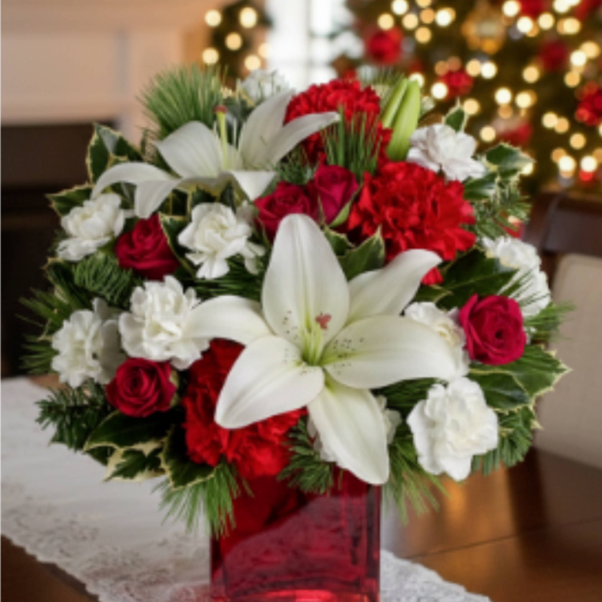 This festive holiday bouquet includes red roses and white asiatic lilies presented