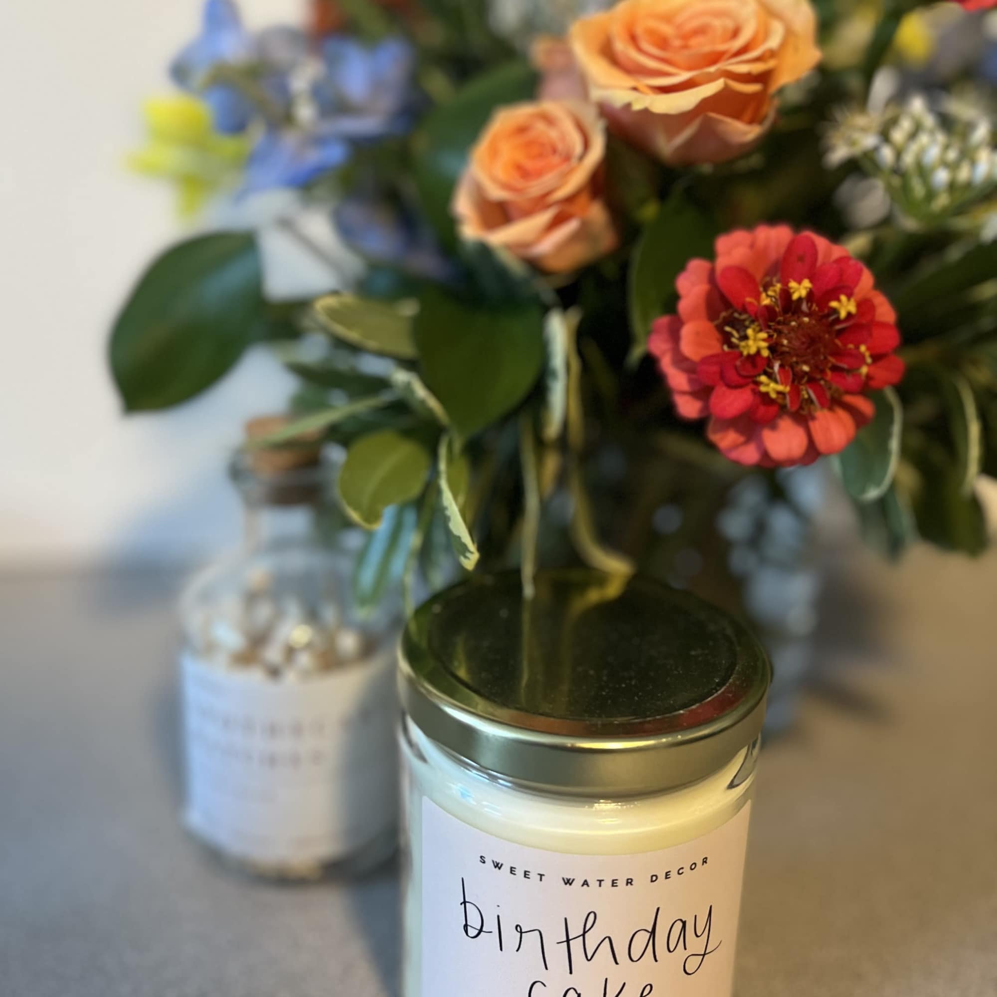 1 petite designers choice arrangement 
1 candle based on theme (specify in