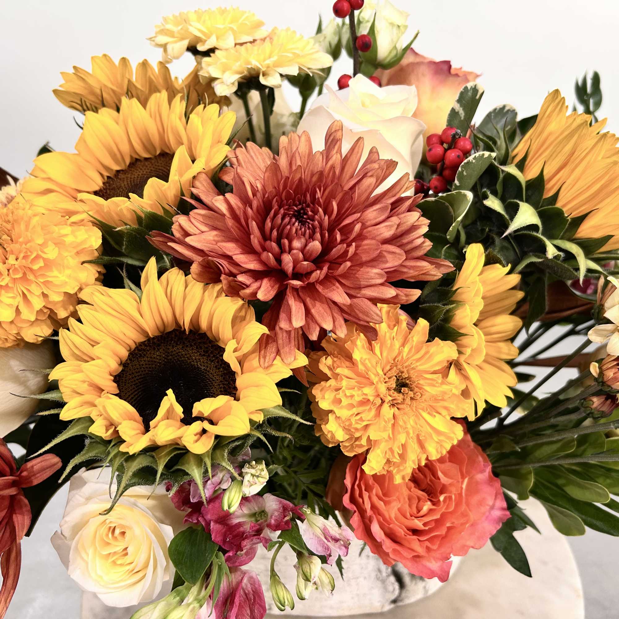 A beautiful birch oval vase with fresh seasonal flowers. Perfect holiday centerpiece.