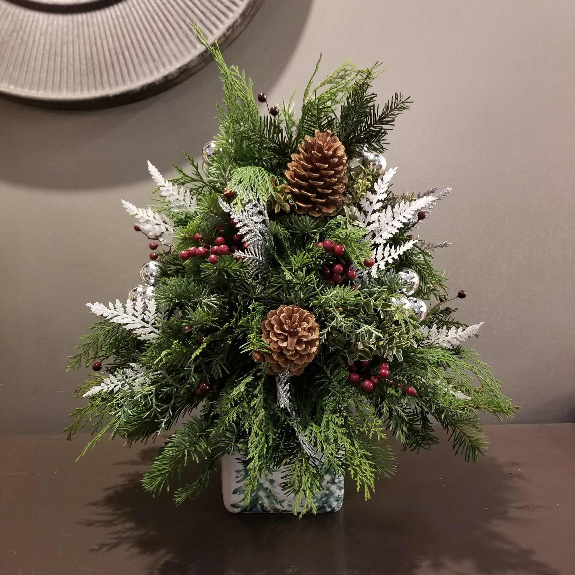 Celebrate the season with this assortment of evergreens created for your table!