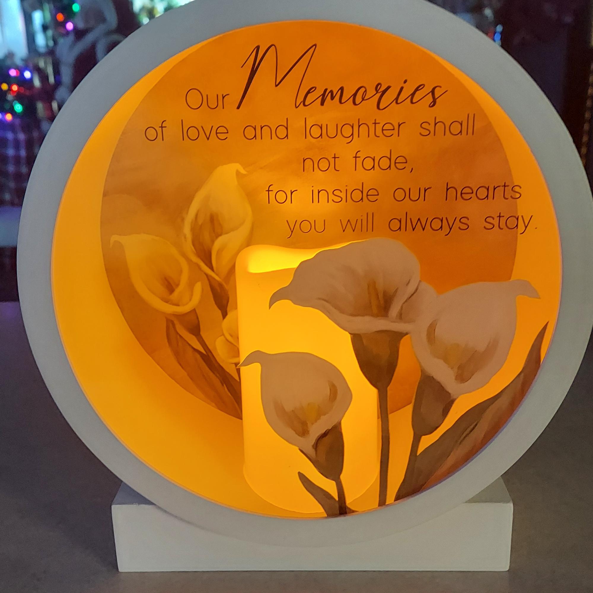 A round shadow box, 10&quot; x 10.75&quot;, with a battery powered candle