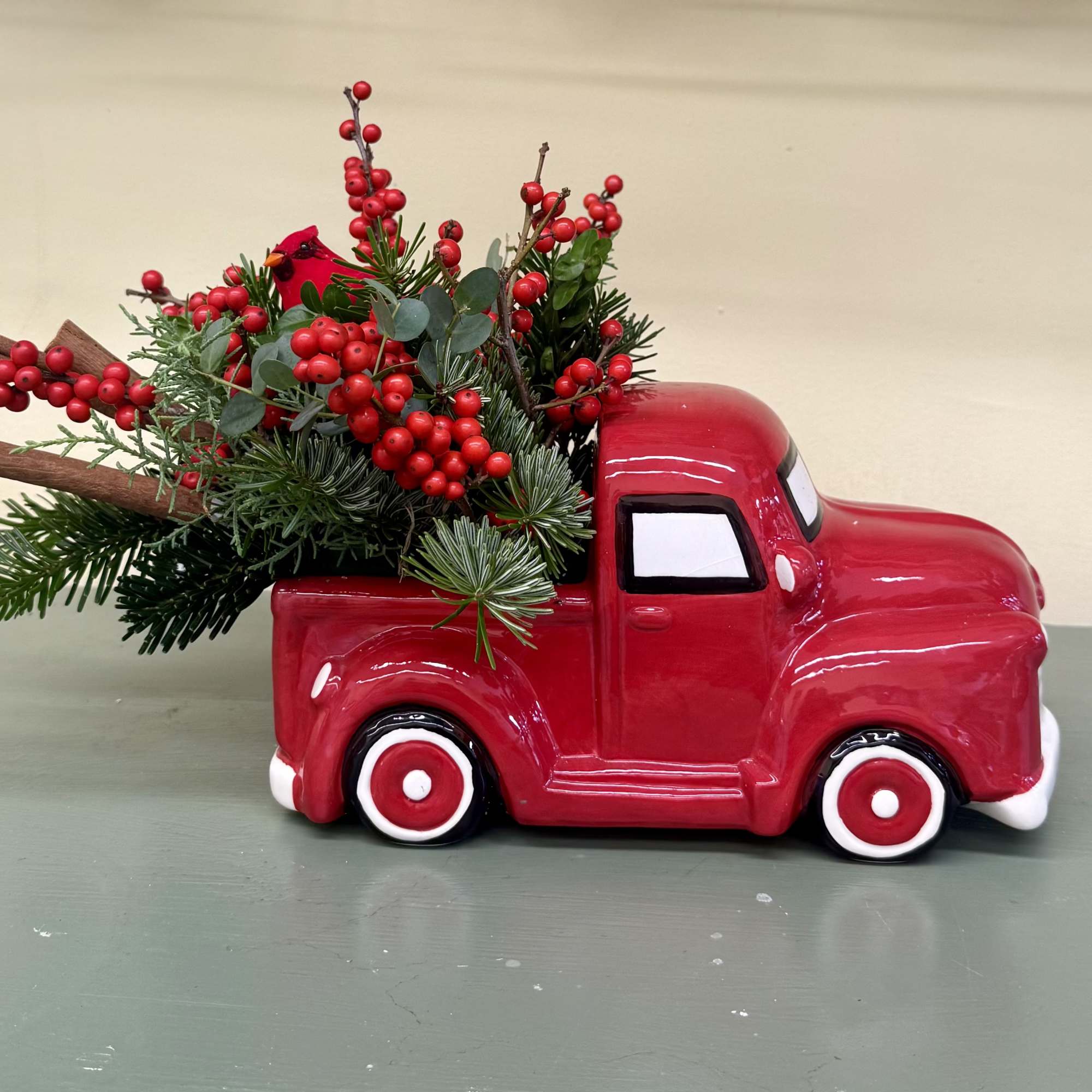 10/5.5 inch red truck vase with holiday greens.