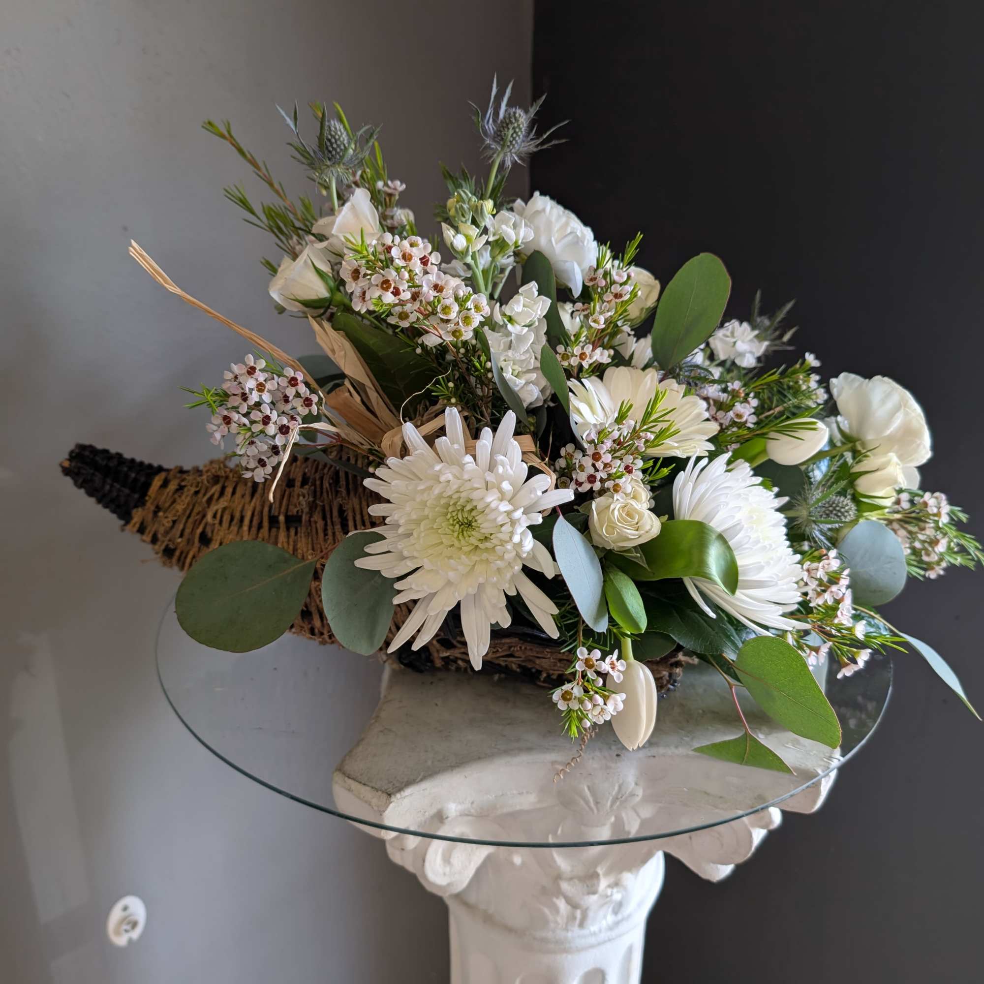 Beautiful arrangement of fresh flowers displayed inside a cornocopia 