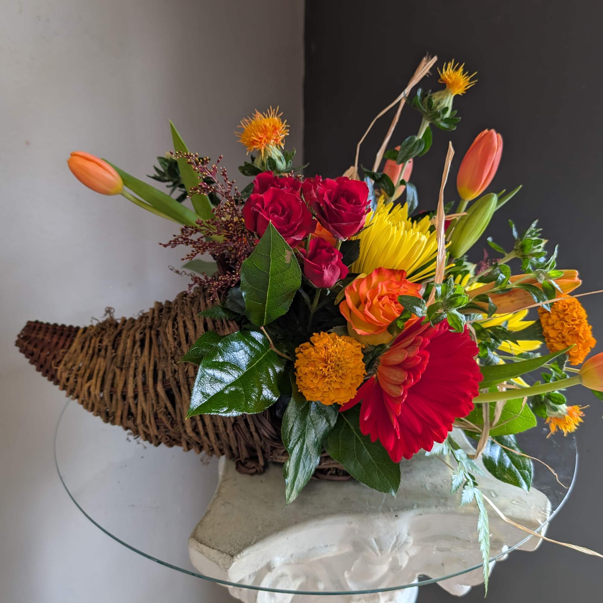 Beautiful arrangement of fresh flowers displayed inside a cornocopia 