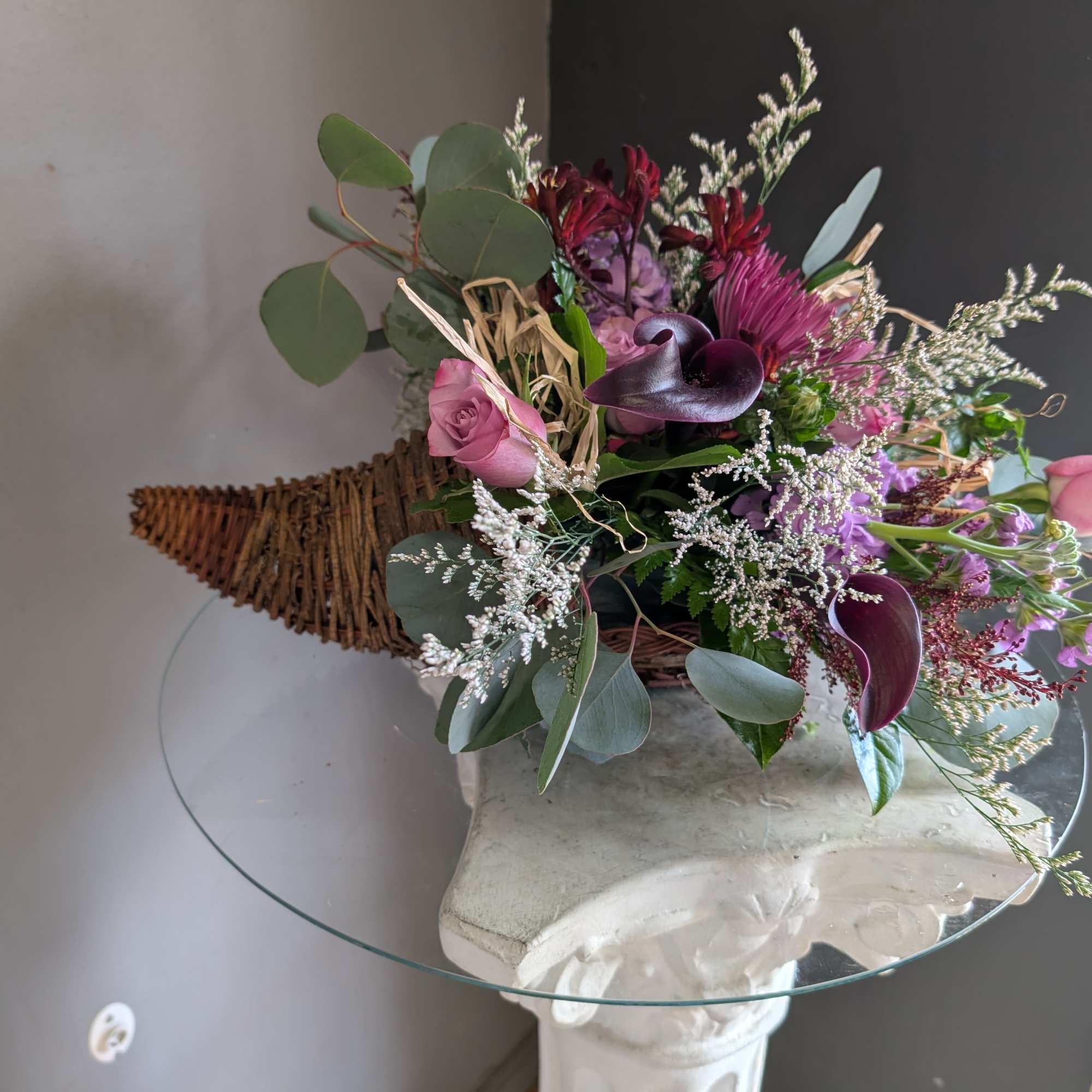 Beautiful arrangement of fresh flowers displayed inside a cornocopia 