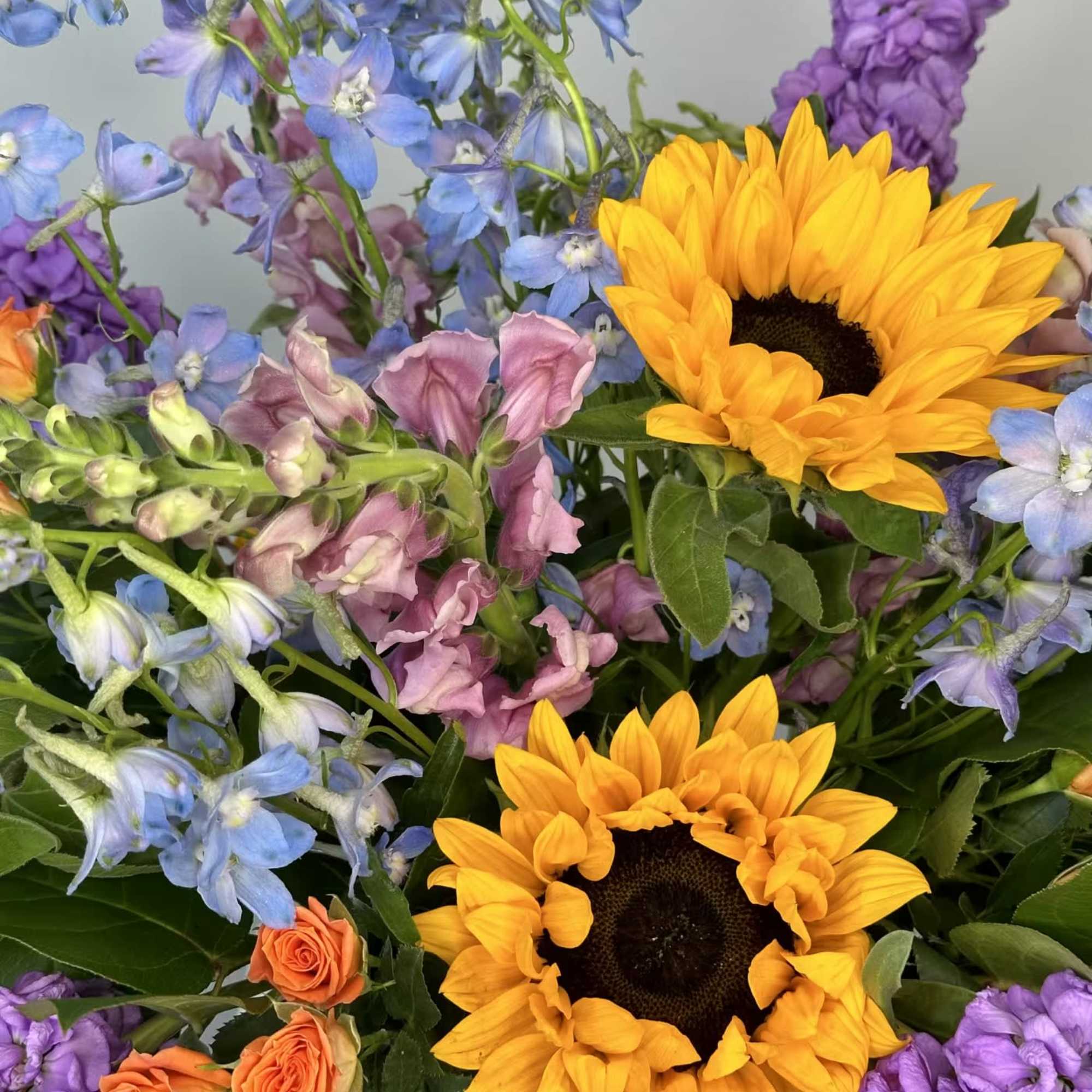 The Full Nest Bouquet is a cheerful, colorful arrangement that has sunflowers