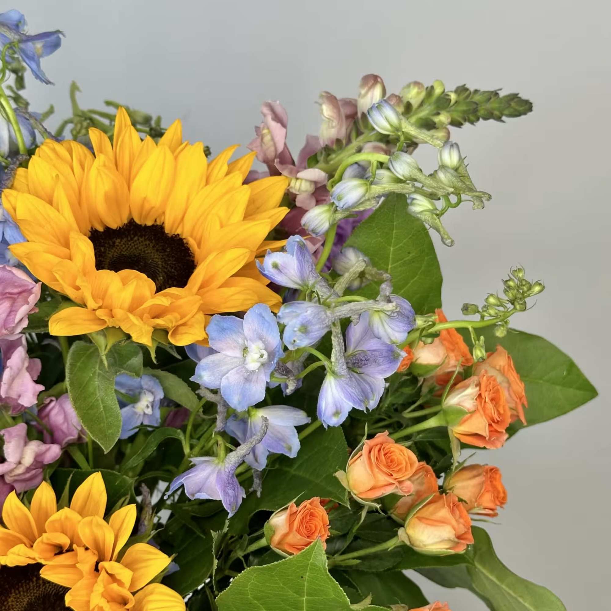 The Full Nest Bouquet is a cheerful, colorful arrangement that has sunflowers